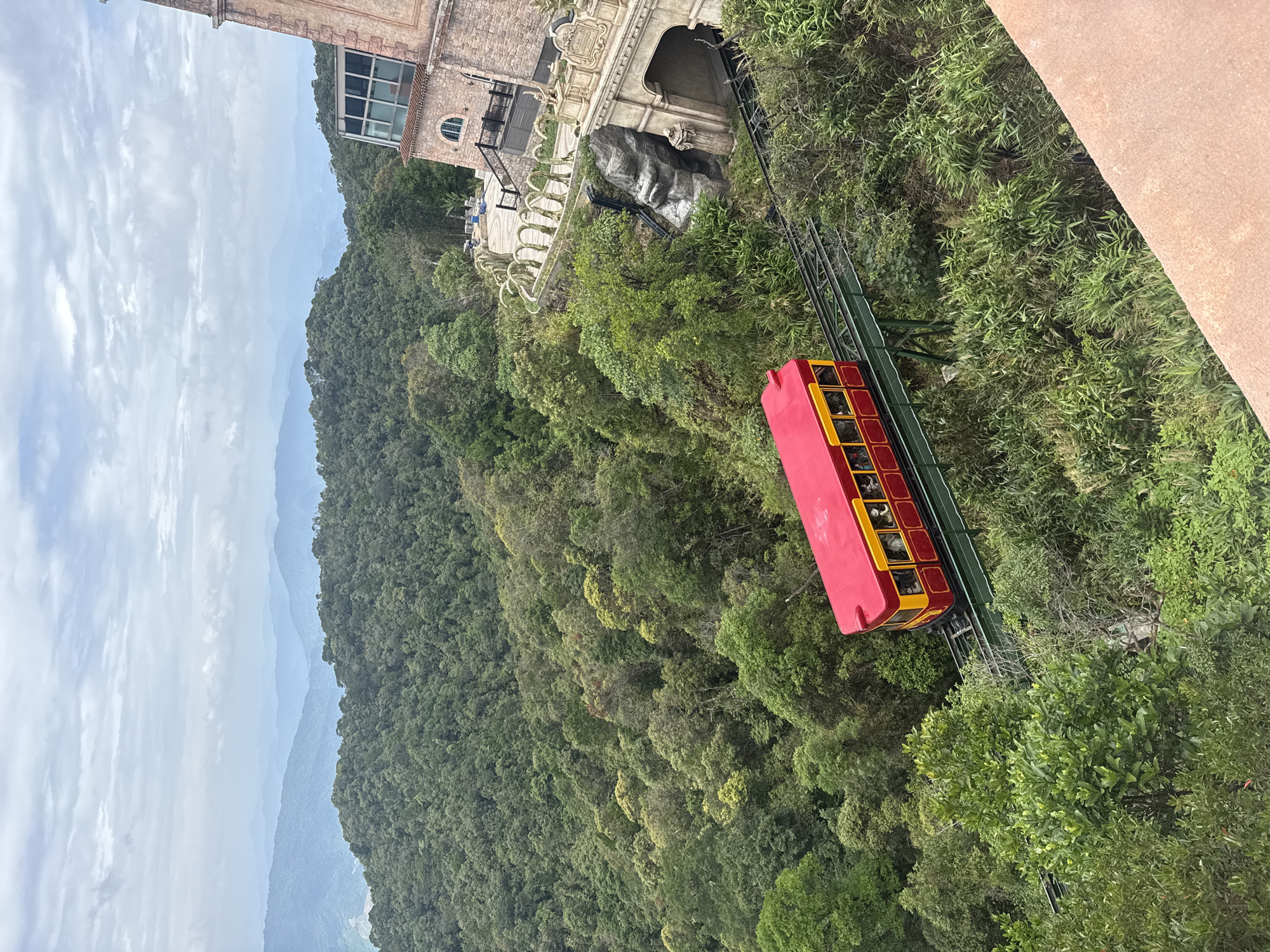 Funicular climbing a green mountain slope near Đà Nẵng