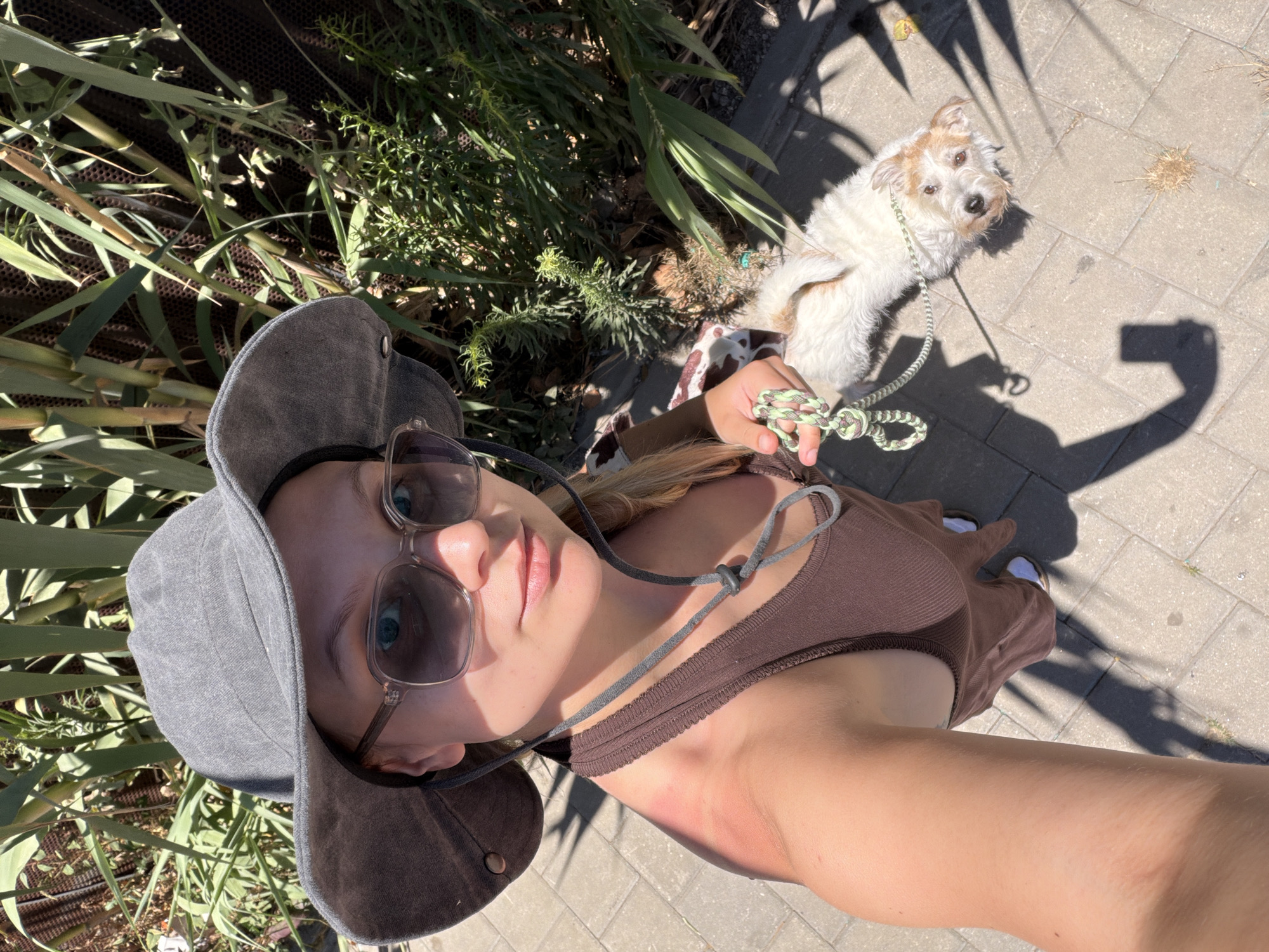 Woman takes sunny day selfies with dog in Tel-Aviv