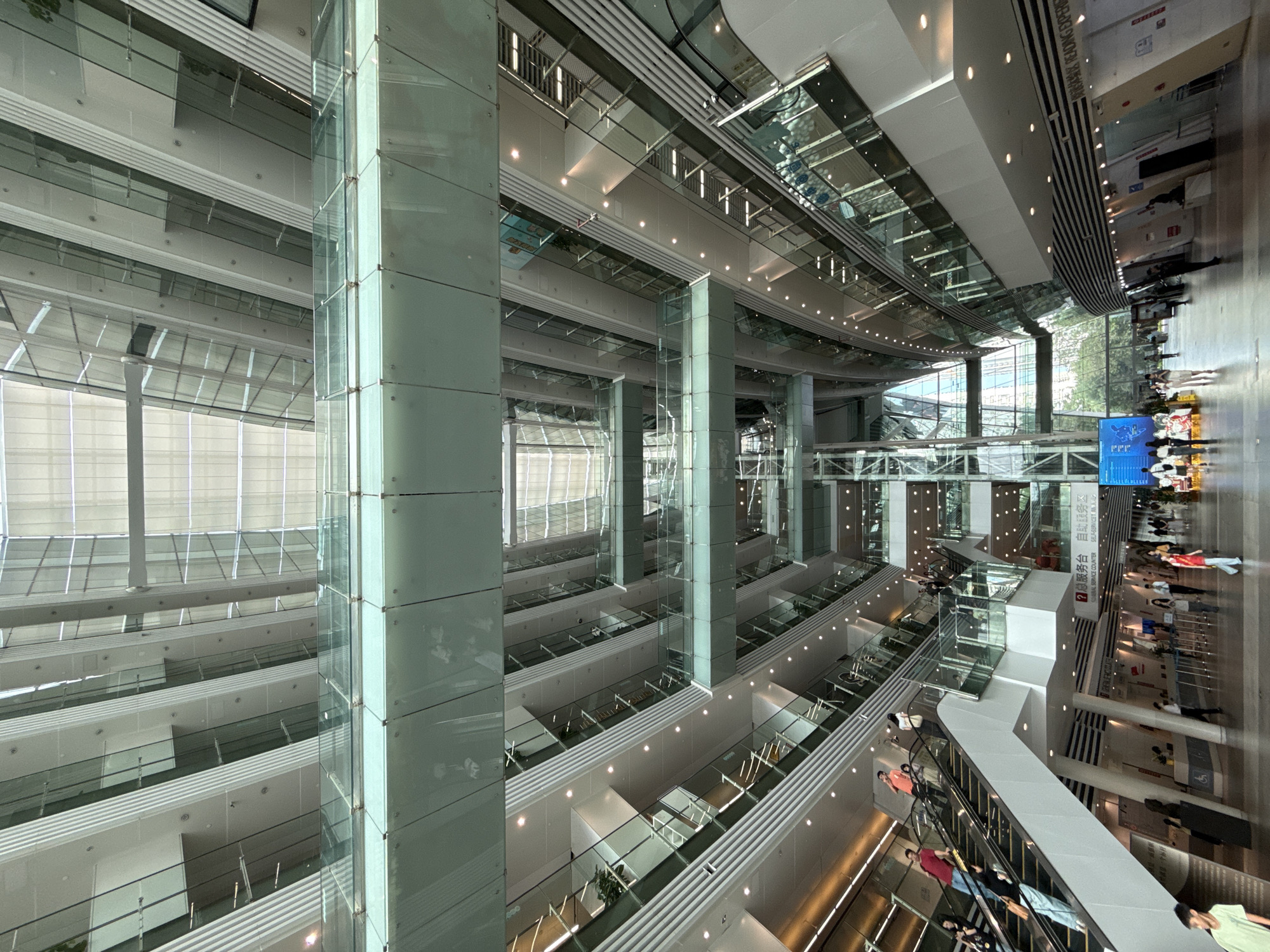 Modern building atrium with glass-steel design documented by observer