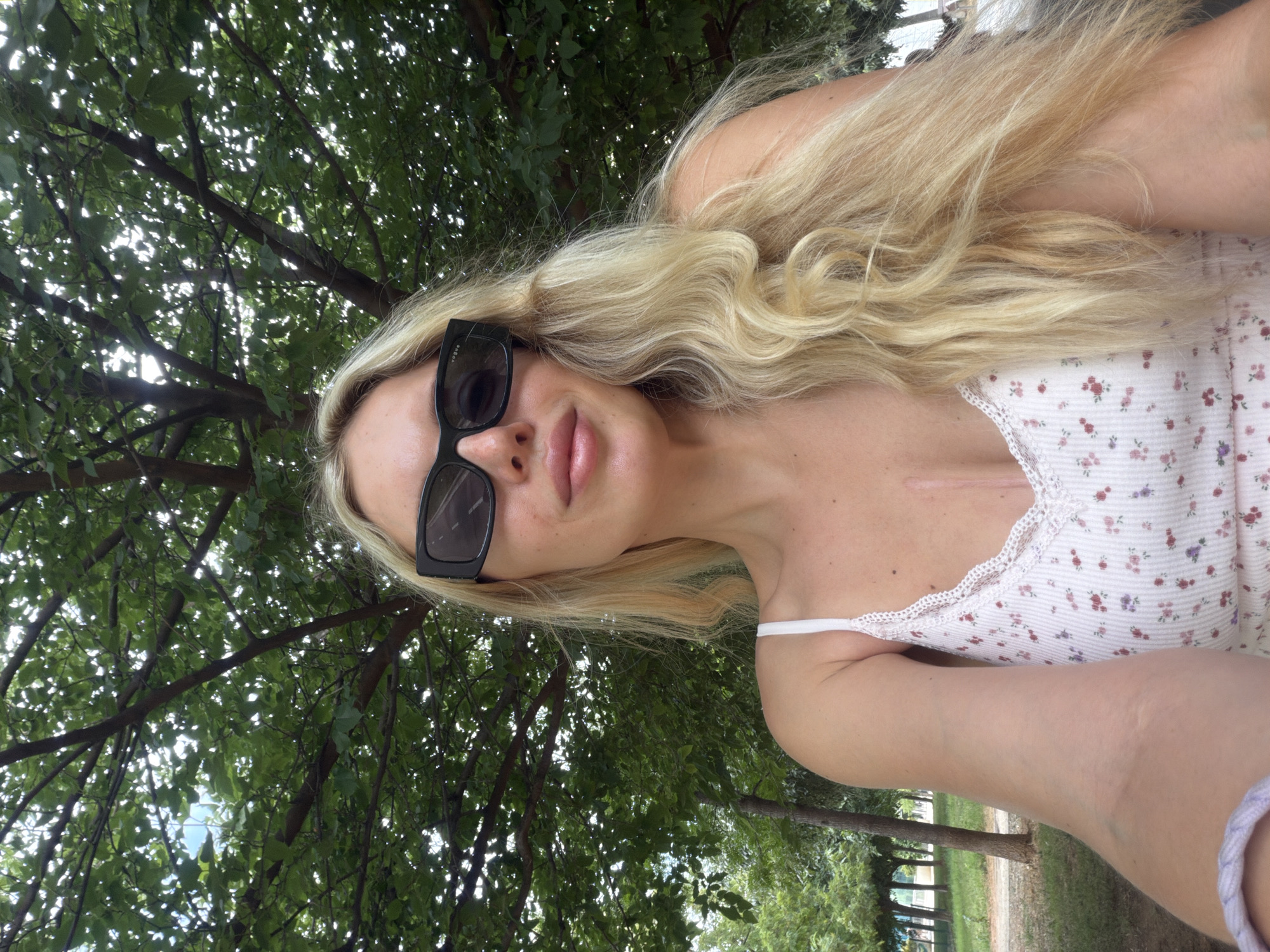 Outdoor selfie under green tree canopy in suburban Valencia