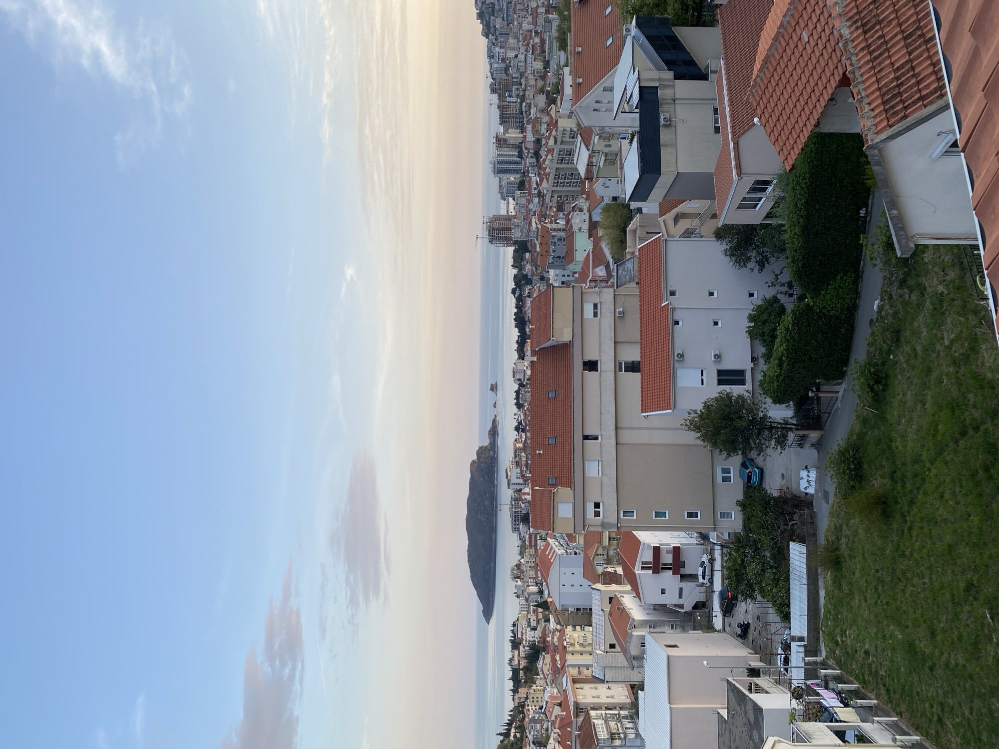 Witness documents evening views of Budva's coastal cityscape
