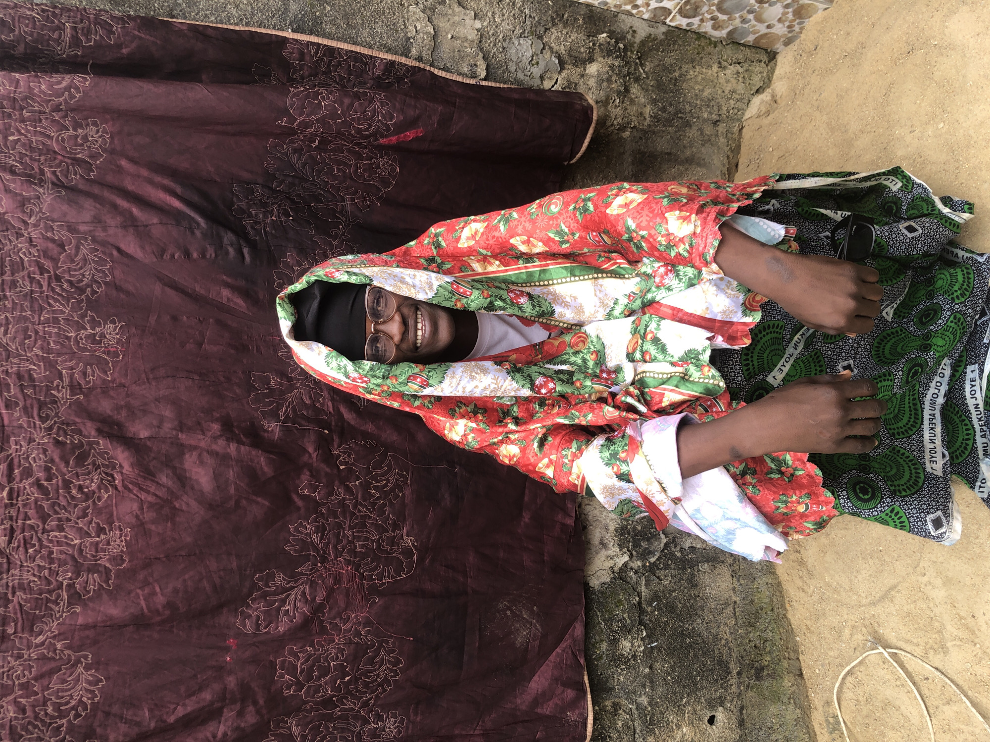 Portrait session against a maroon cloth backdrop in Ado, Nigeria