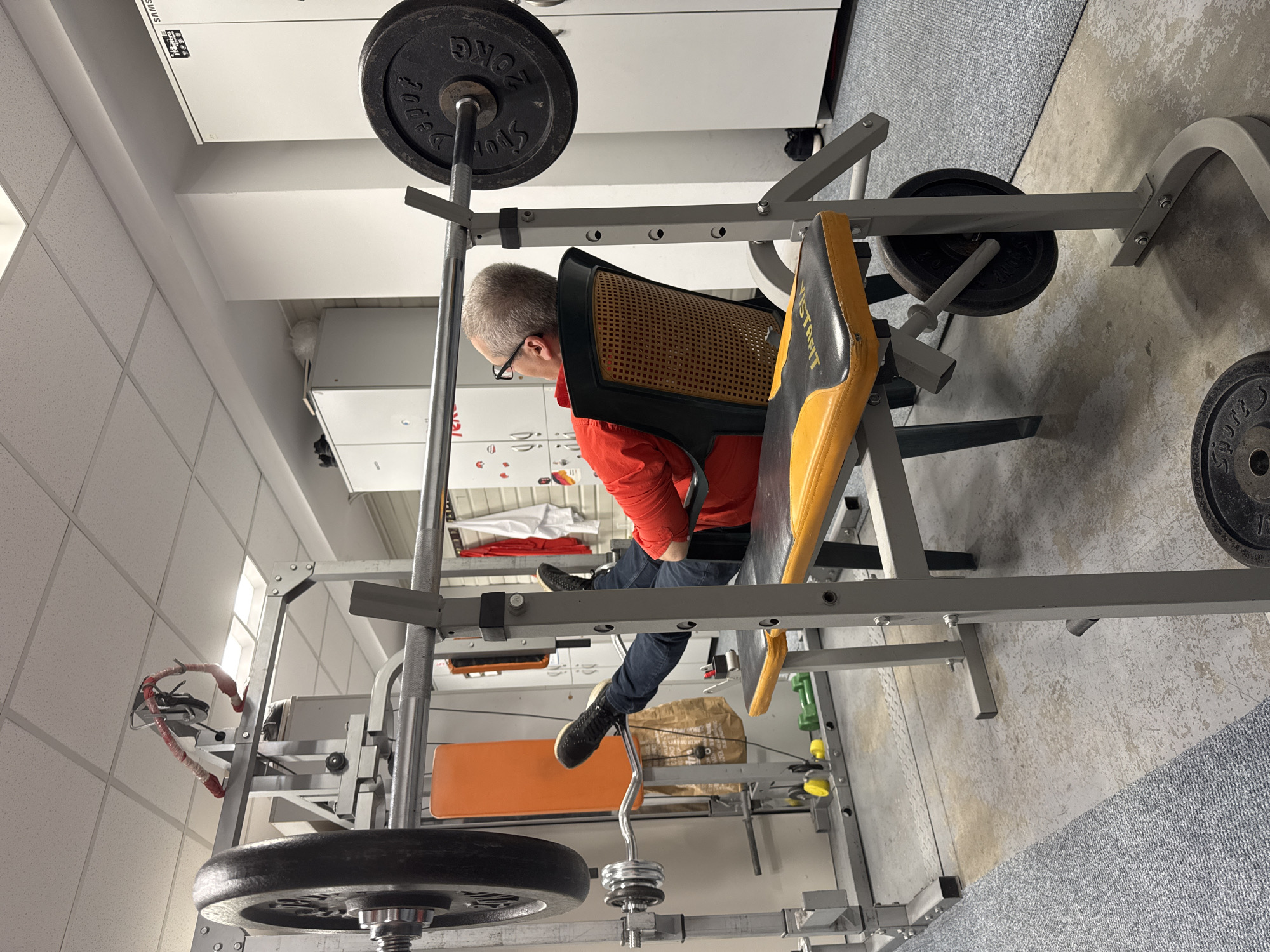 Man sits on weight bench in Sofia home gym
