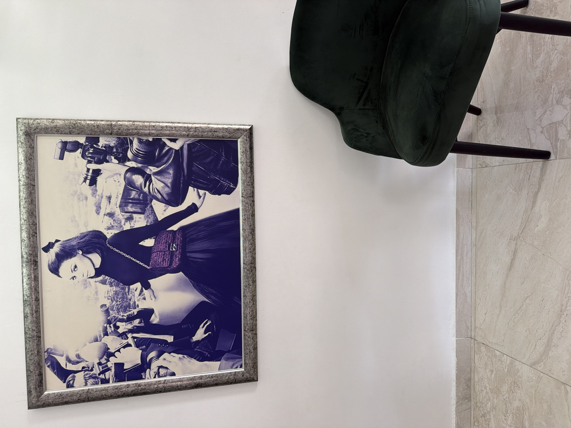Framed portrait photographed beside green chair in Malta home