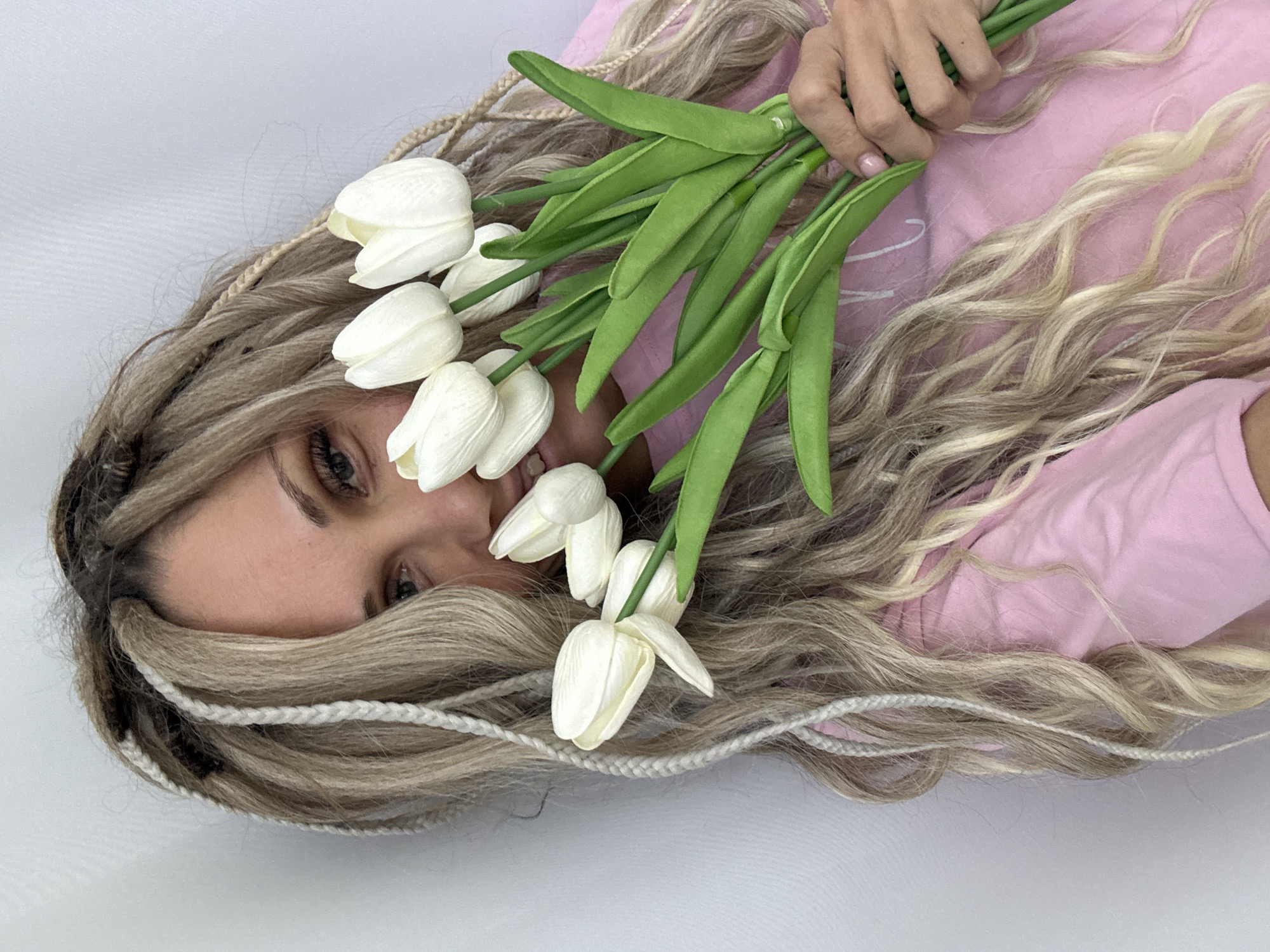 Woman poses with flowers and accessories in Rusanovo photoshoot