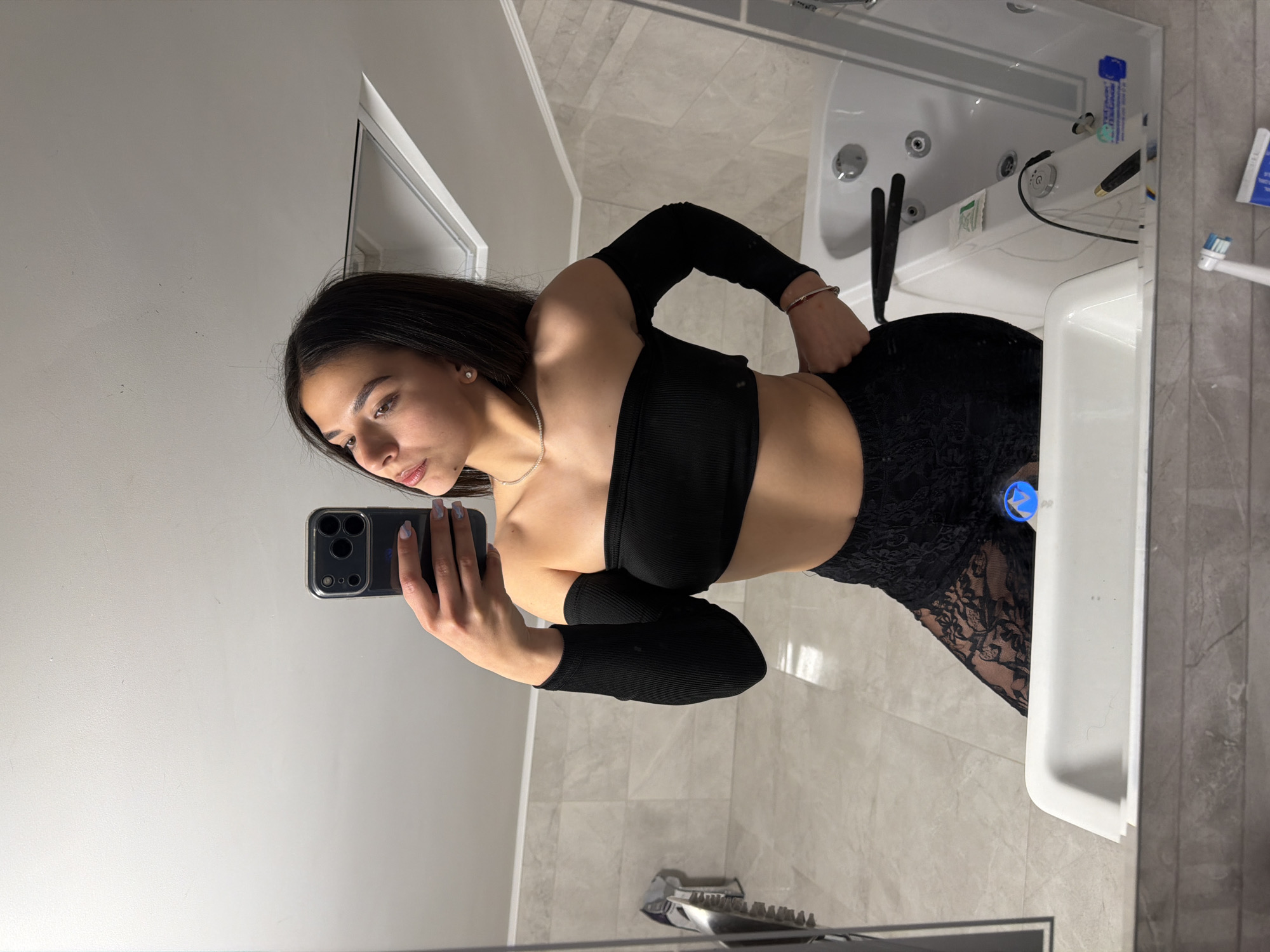 Woman takes bathroom mirror selfies in Gabrovo, Bulgaria