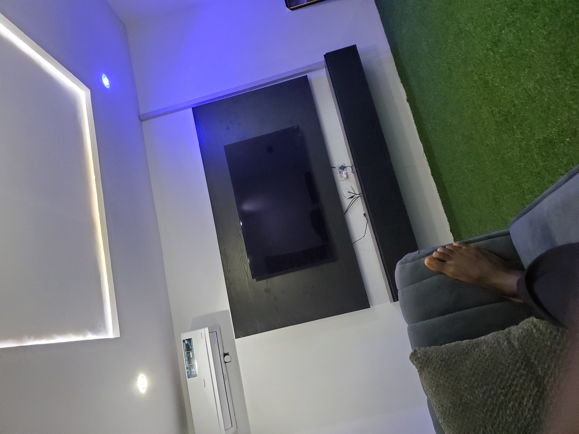 Modern living room with LED-accented entertainment setup documented