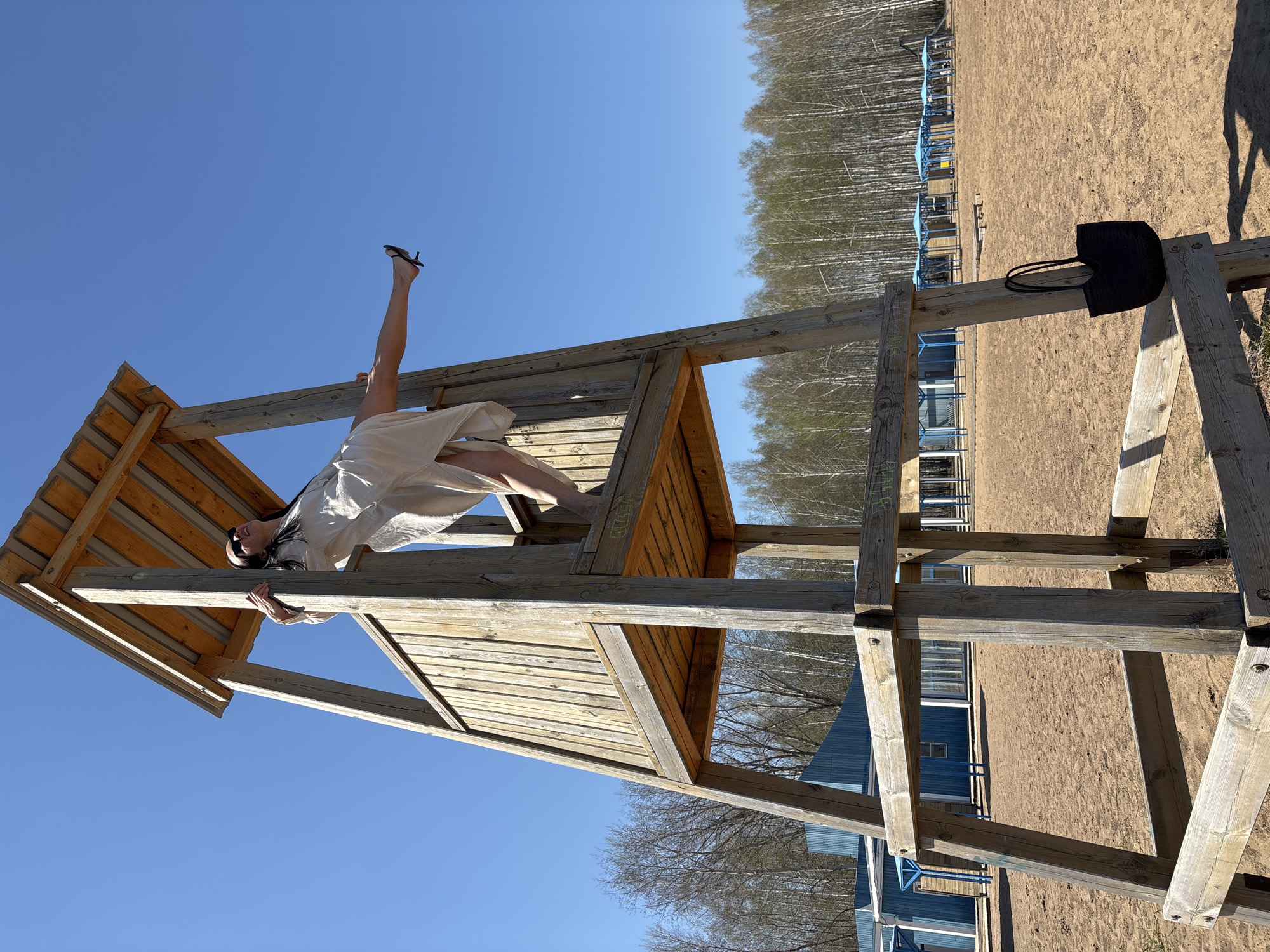 Woman performs acrobatics on playground equipment in Chaikovsky
