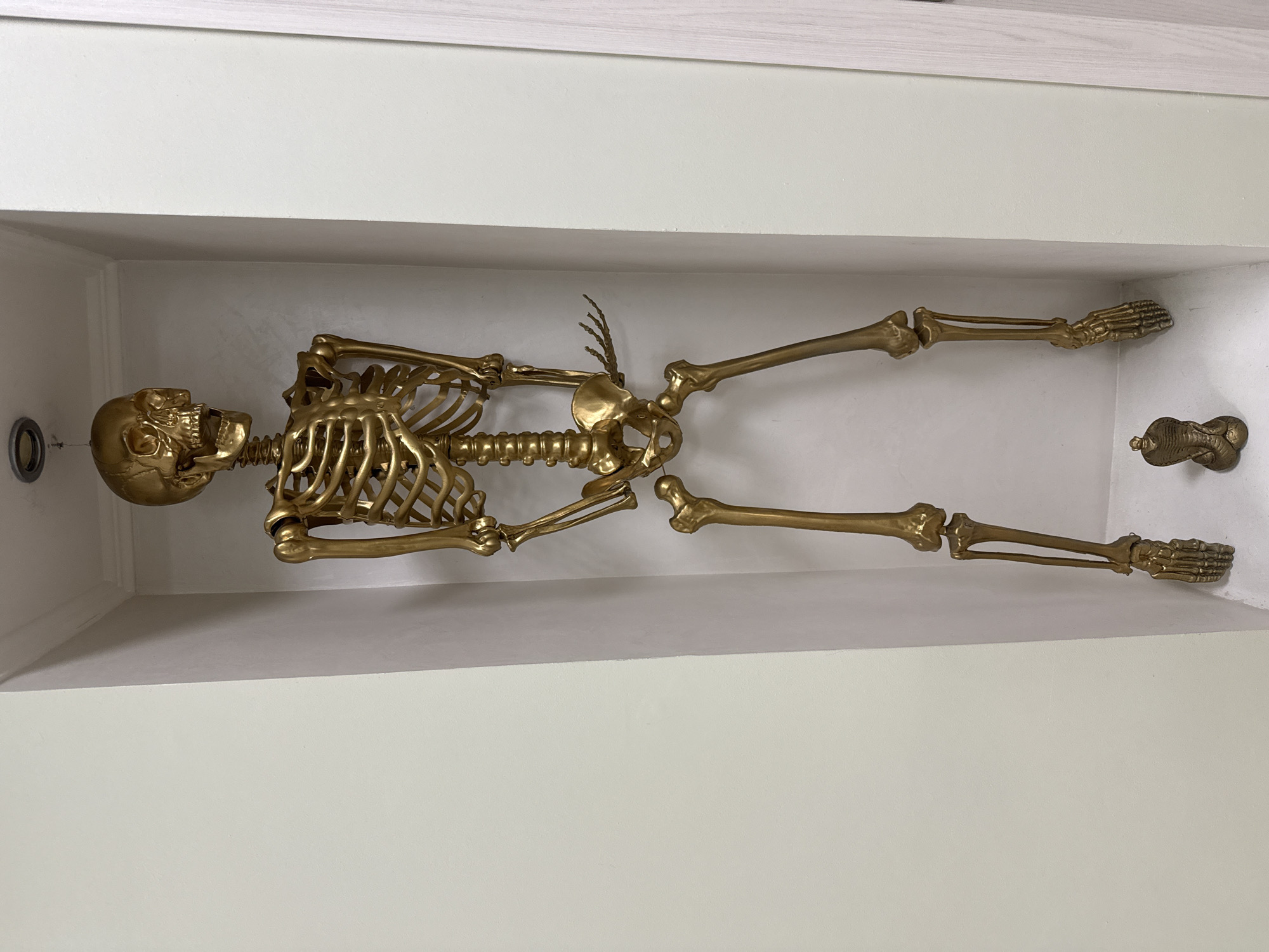 Inside an ornate Khimki metro station with a golden skeleton display