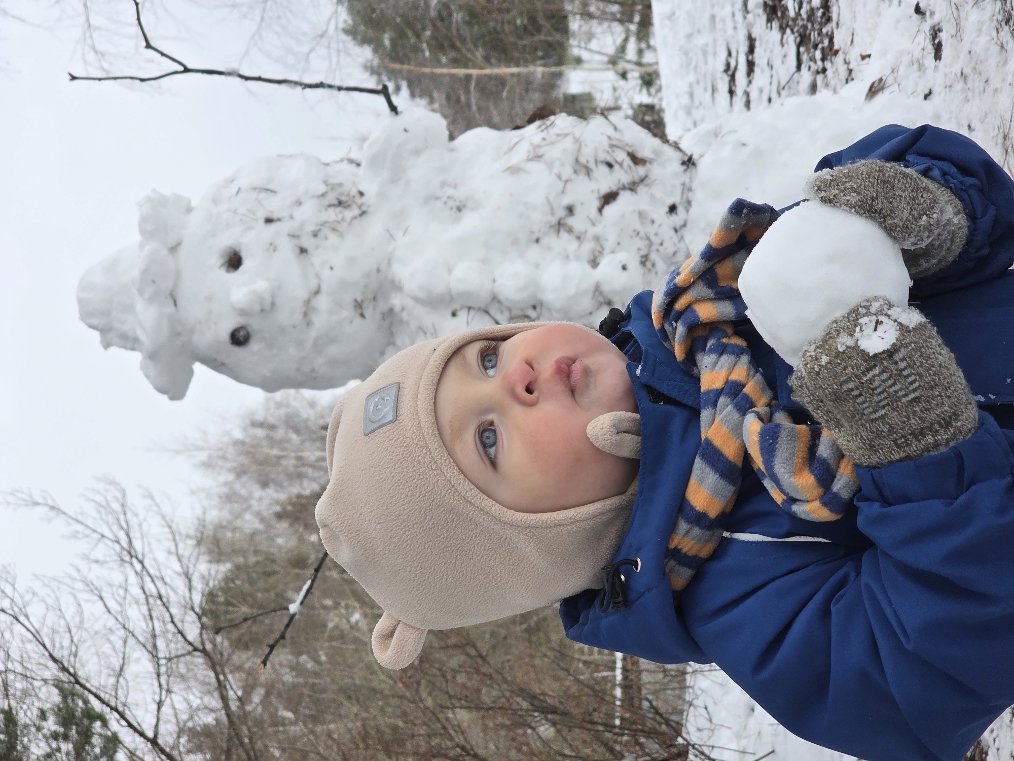 Child plays in snow, dog gets treats in Chaikovsky