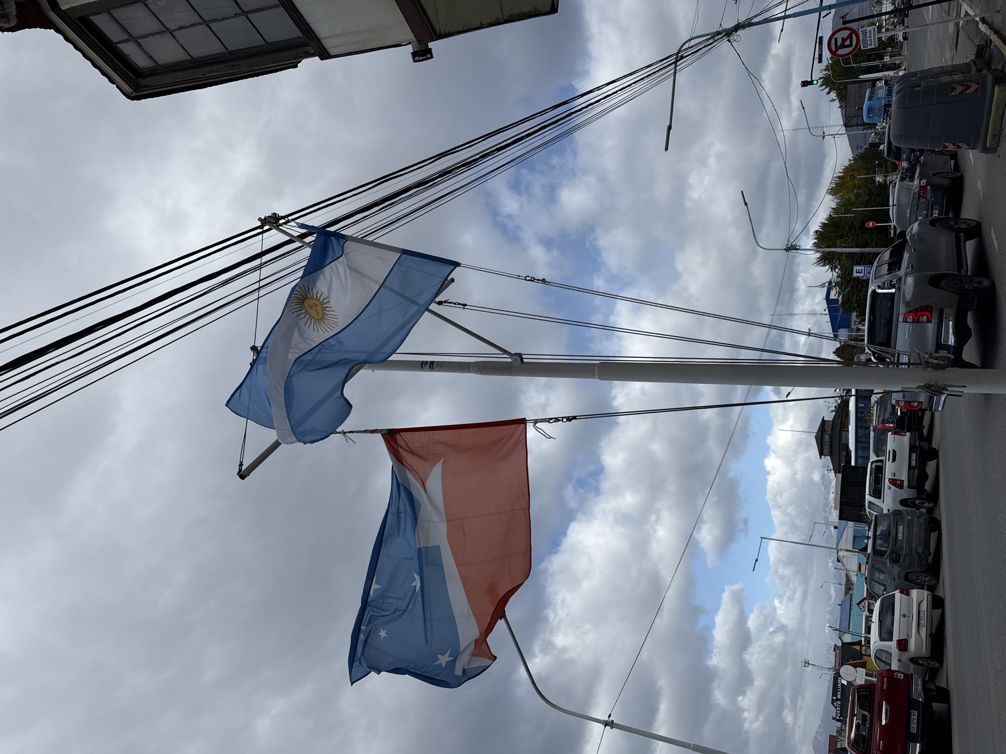 Argentine flags displayed on street pole in Ushuaia