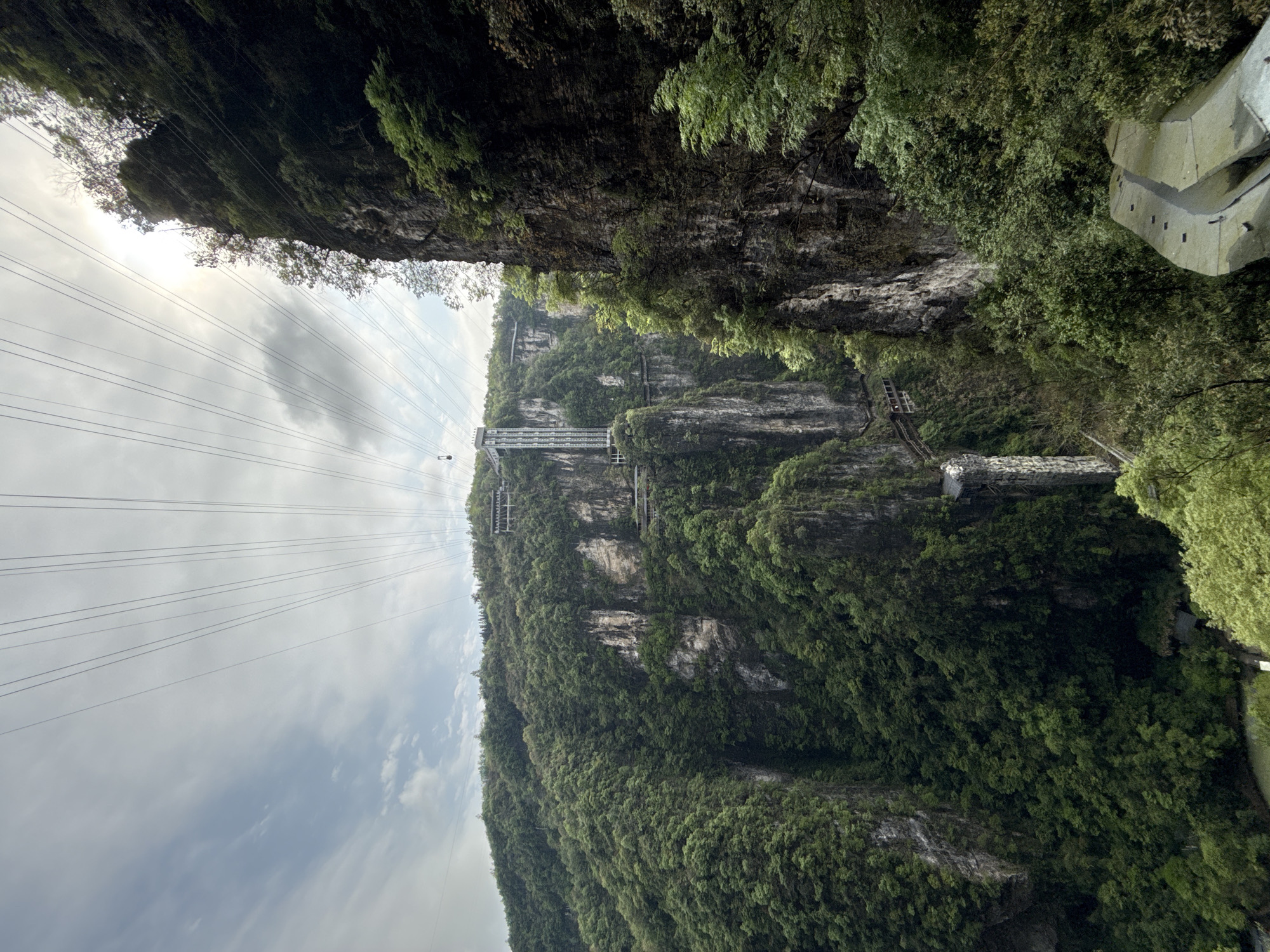 Glass bridge and power lines documented in Zhangjiajie mountains