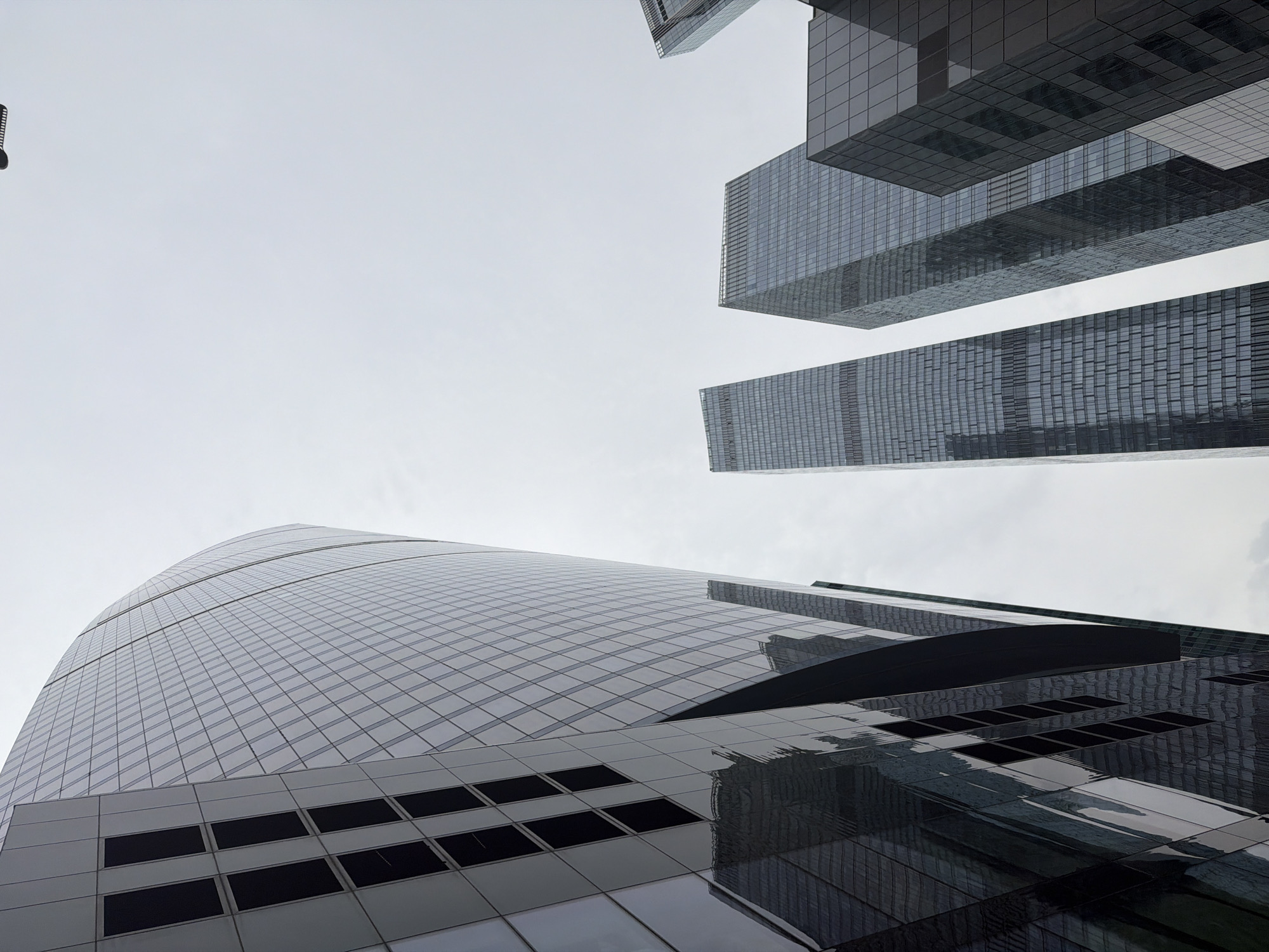 Street-level views of Moscow City's glass skyscrapers on a grey morning