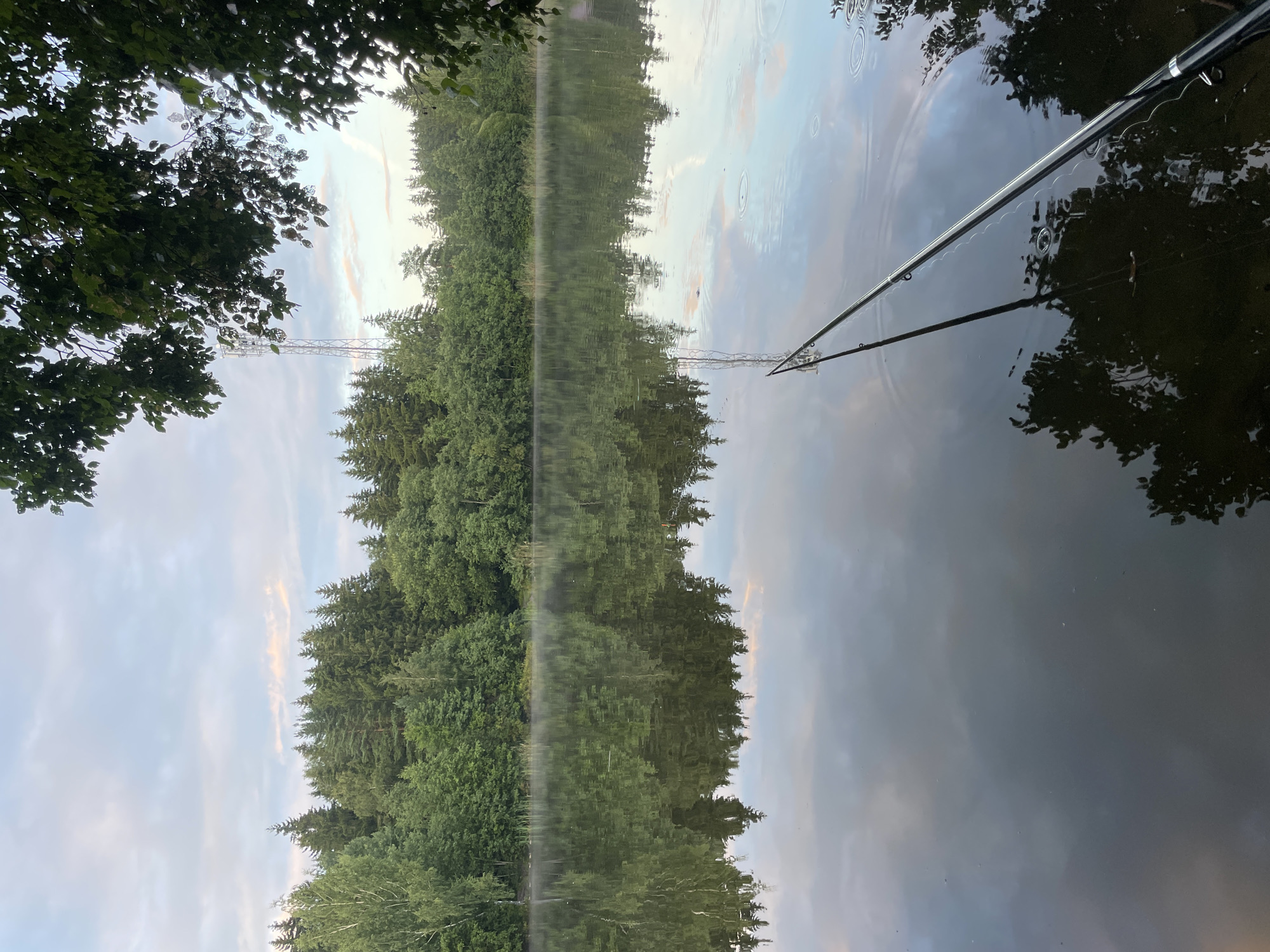 Evening fishing on a misty Russian lake at dusk