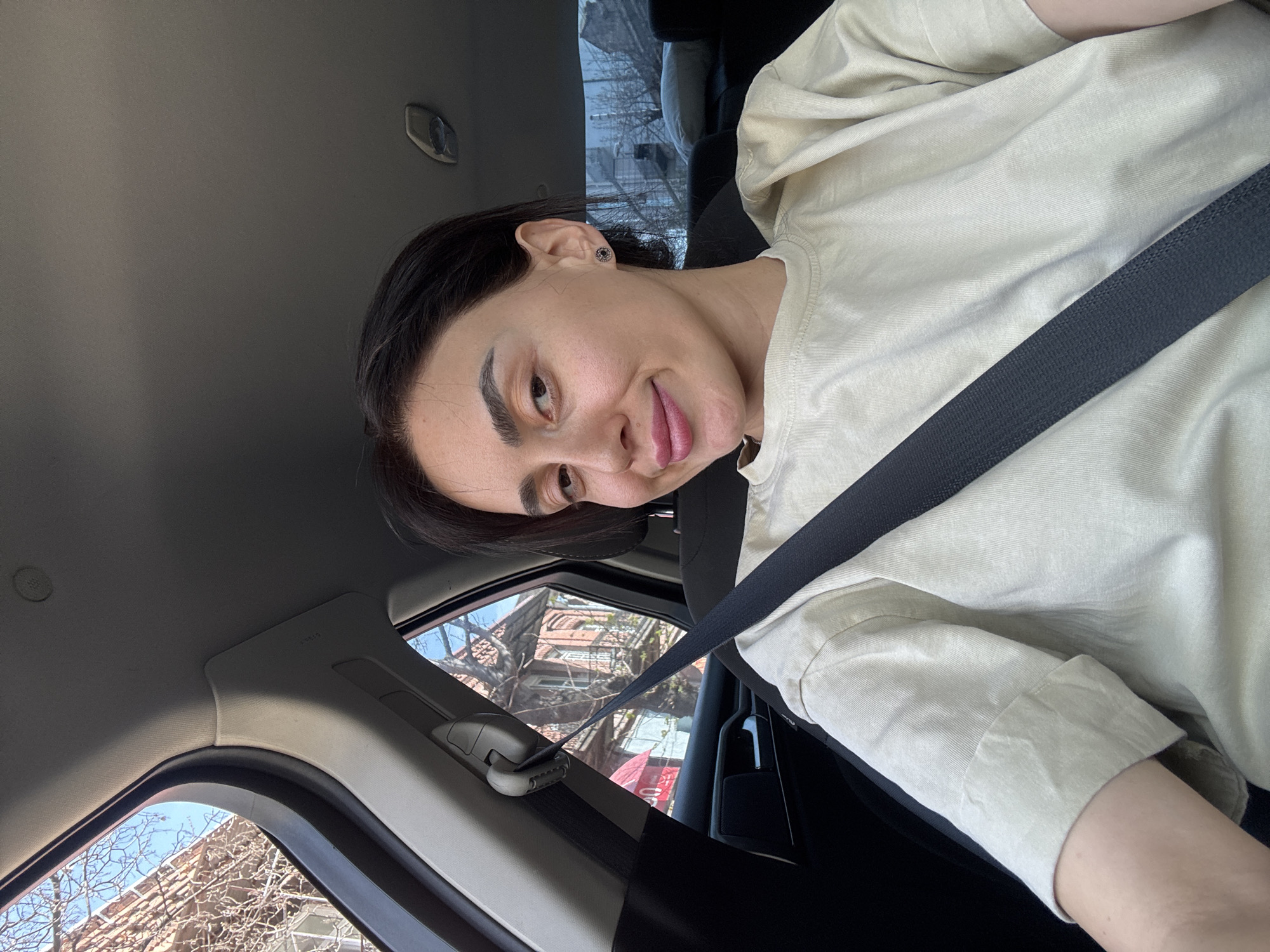 Woman photographed during car journey through Tbilisi streets