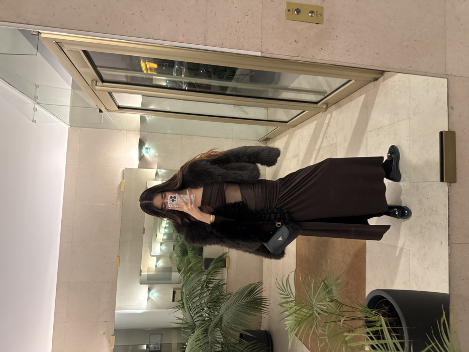 Woman takes mirror selfies in brown dress, Paris