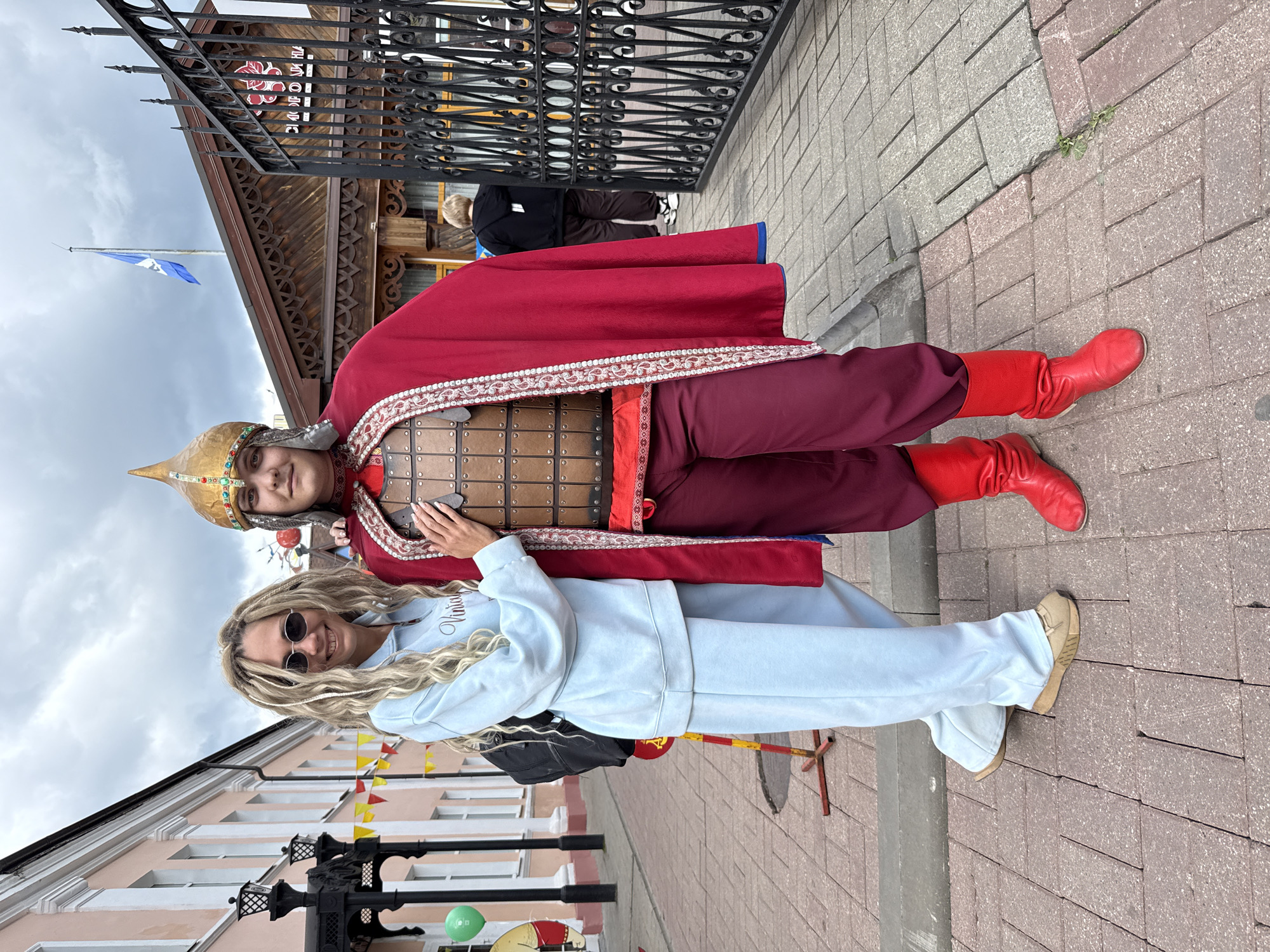 Visitors pose at Russian monument with historical costumes in Rusanovo