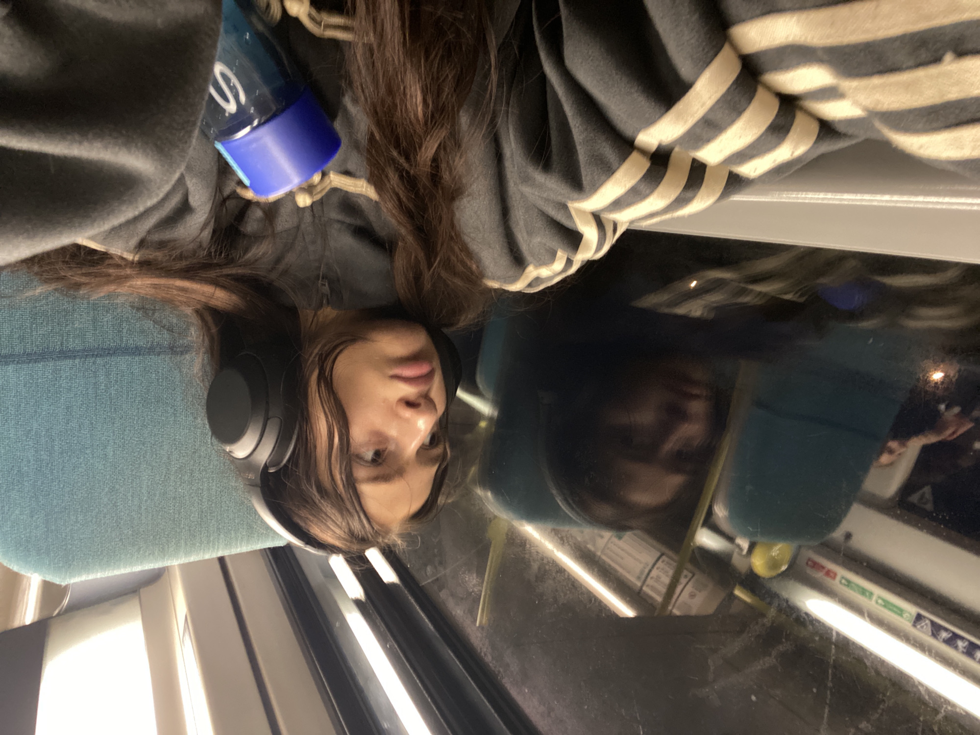 Woman rests against window during London transit journey