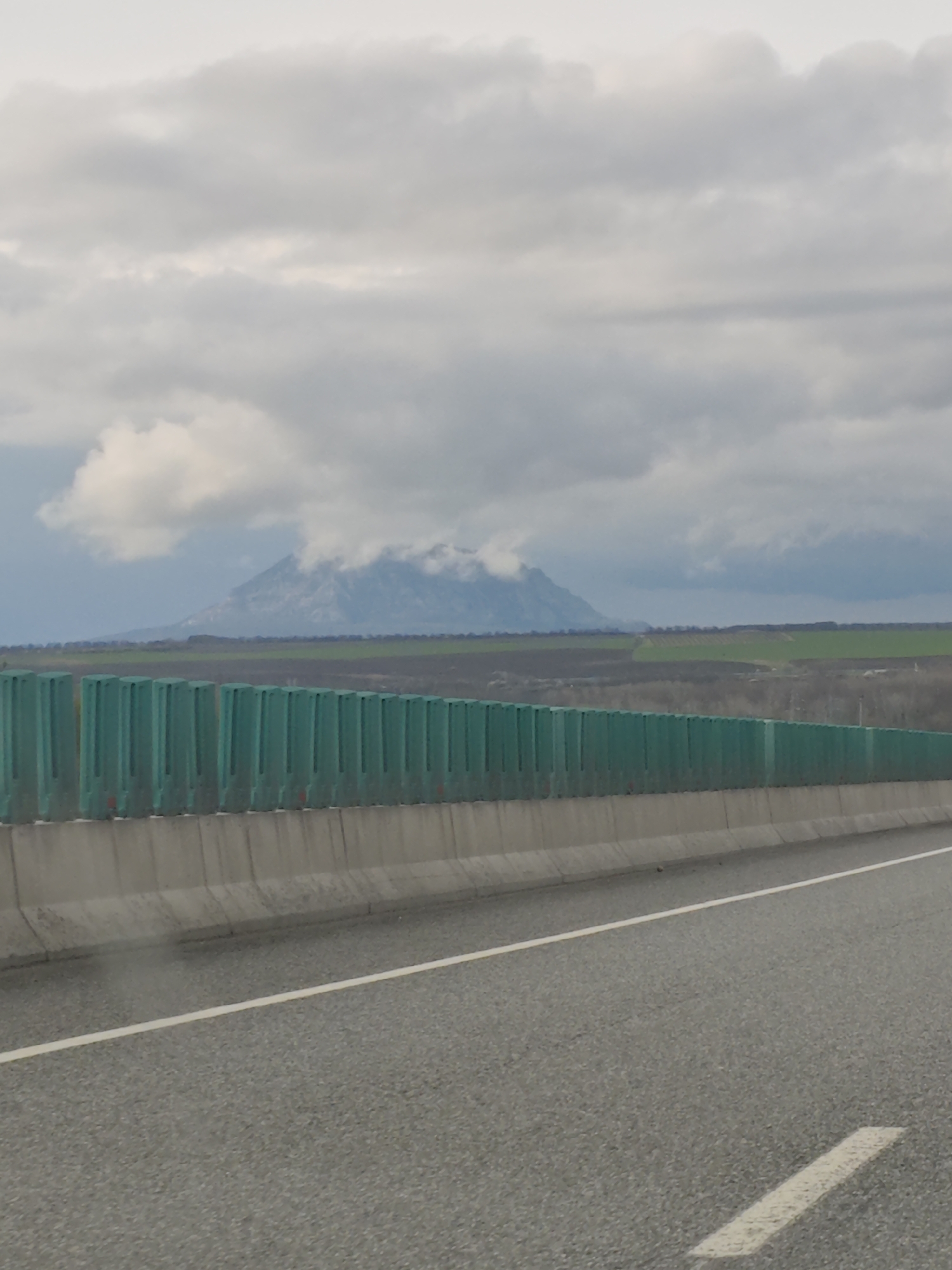 Highway scene documented in Konstantinovskaya with mountain backdrop