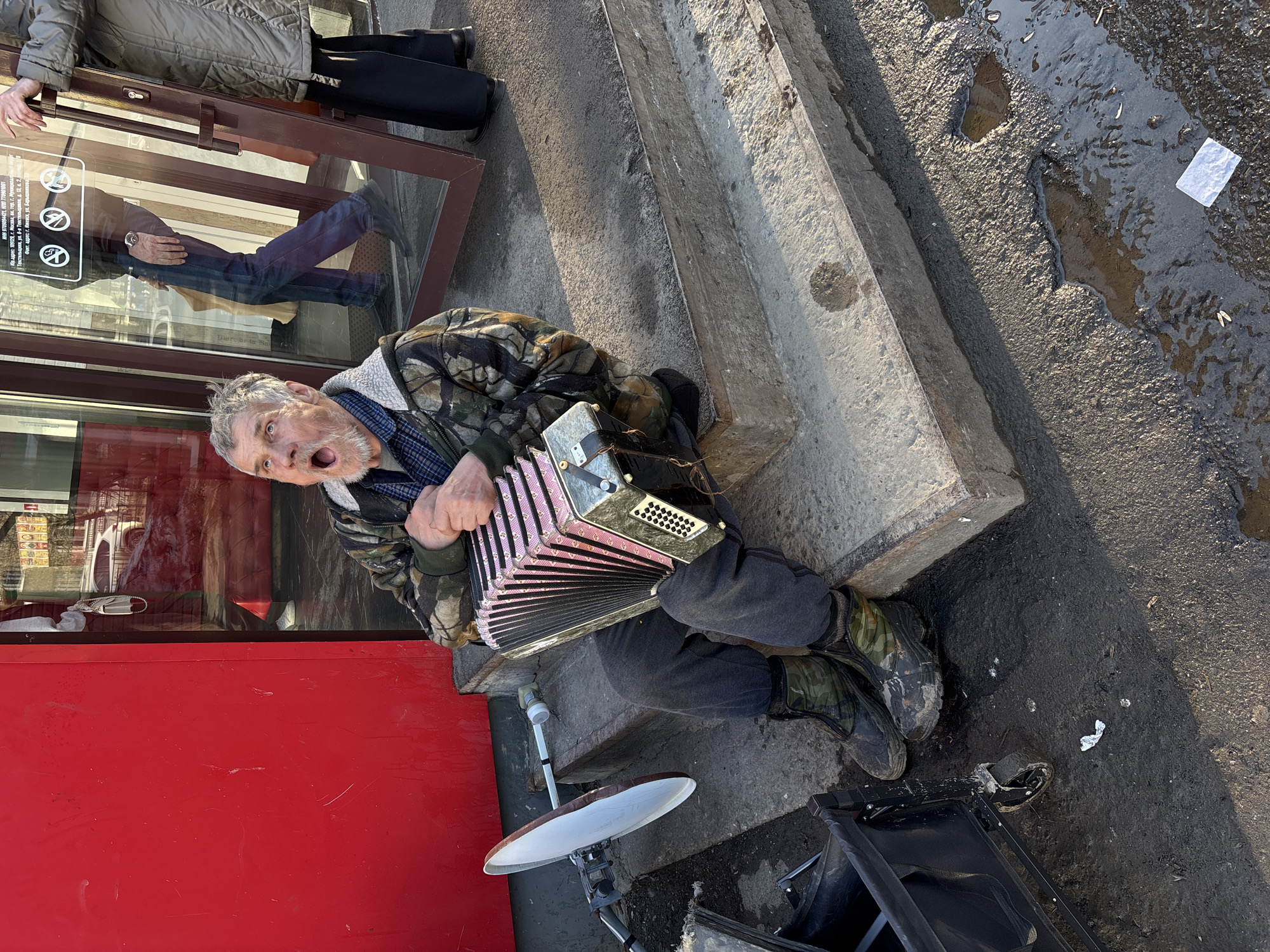 Street musician and child at play captured in Izhevsk