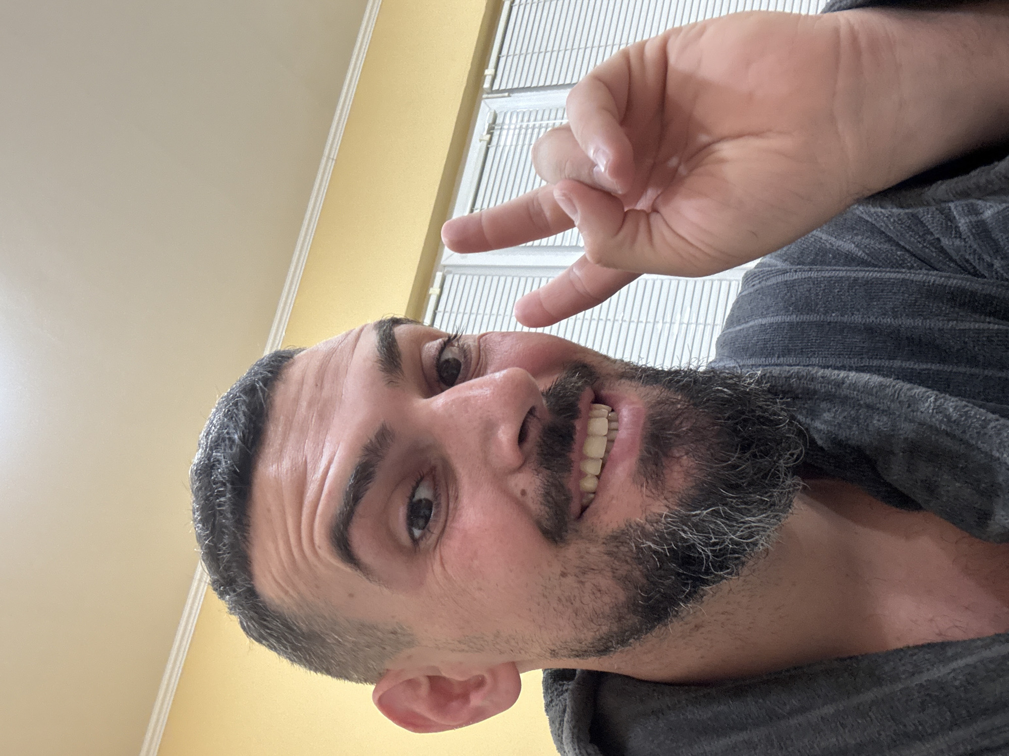 Man in gray robe makes hang loose gesture in Bulgaria