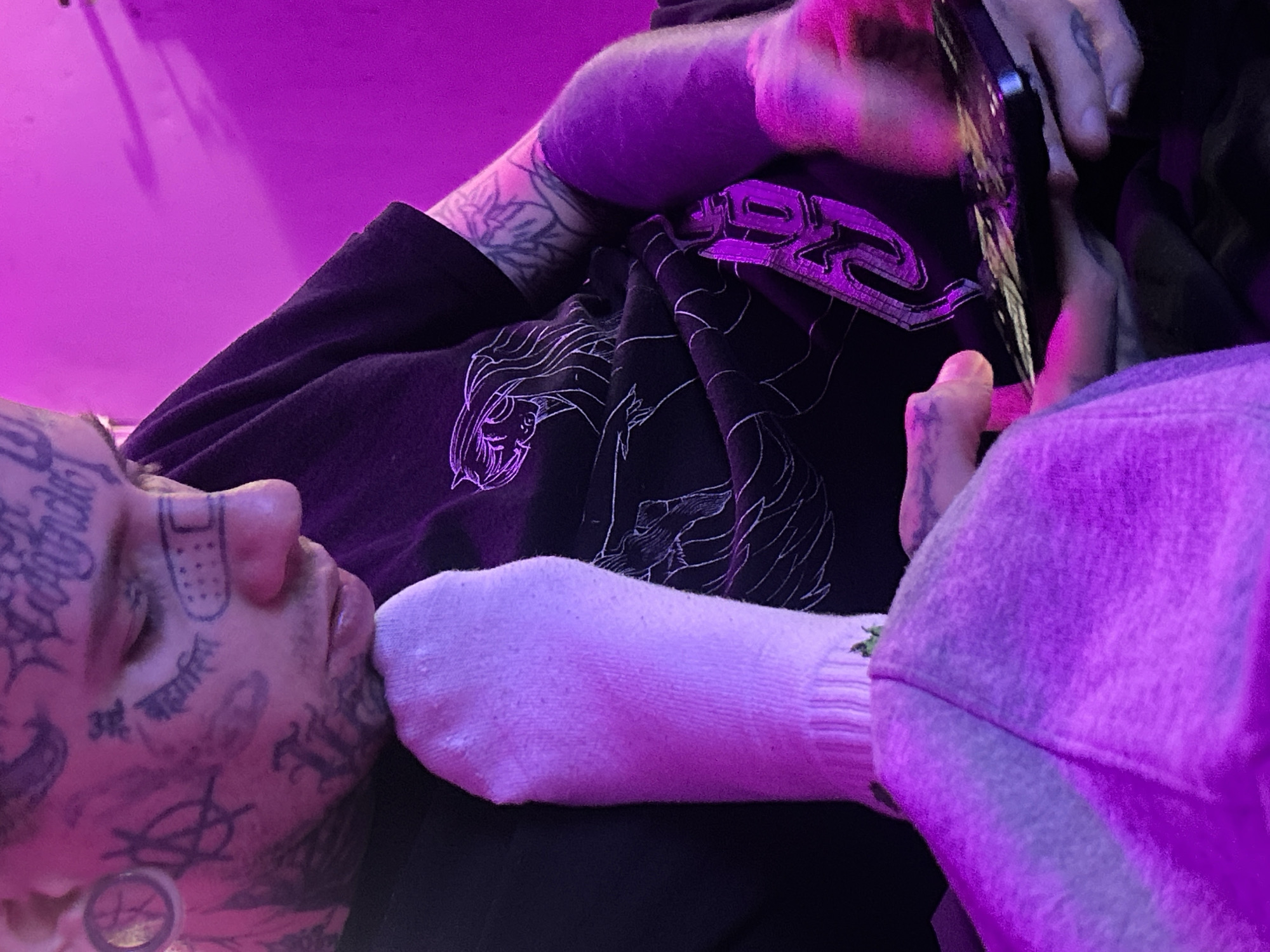 Tattooed person resting indoors, Fortnite gameplay captured in Buenos Aires