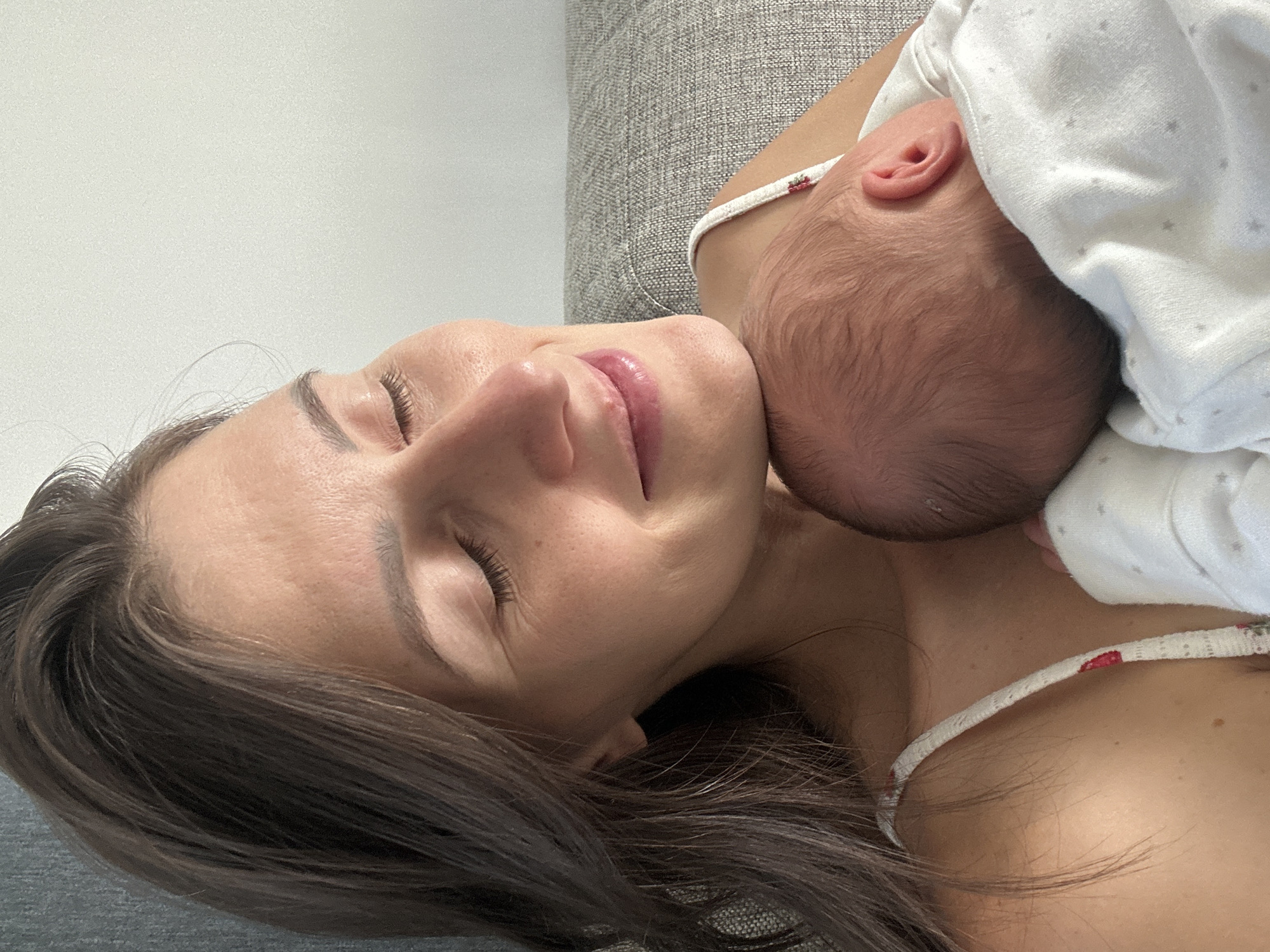 Mother holds newborn baby in intimate moment in Wisła