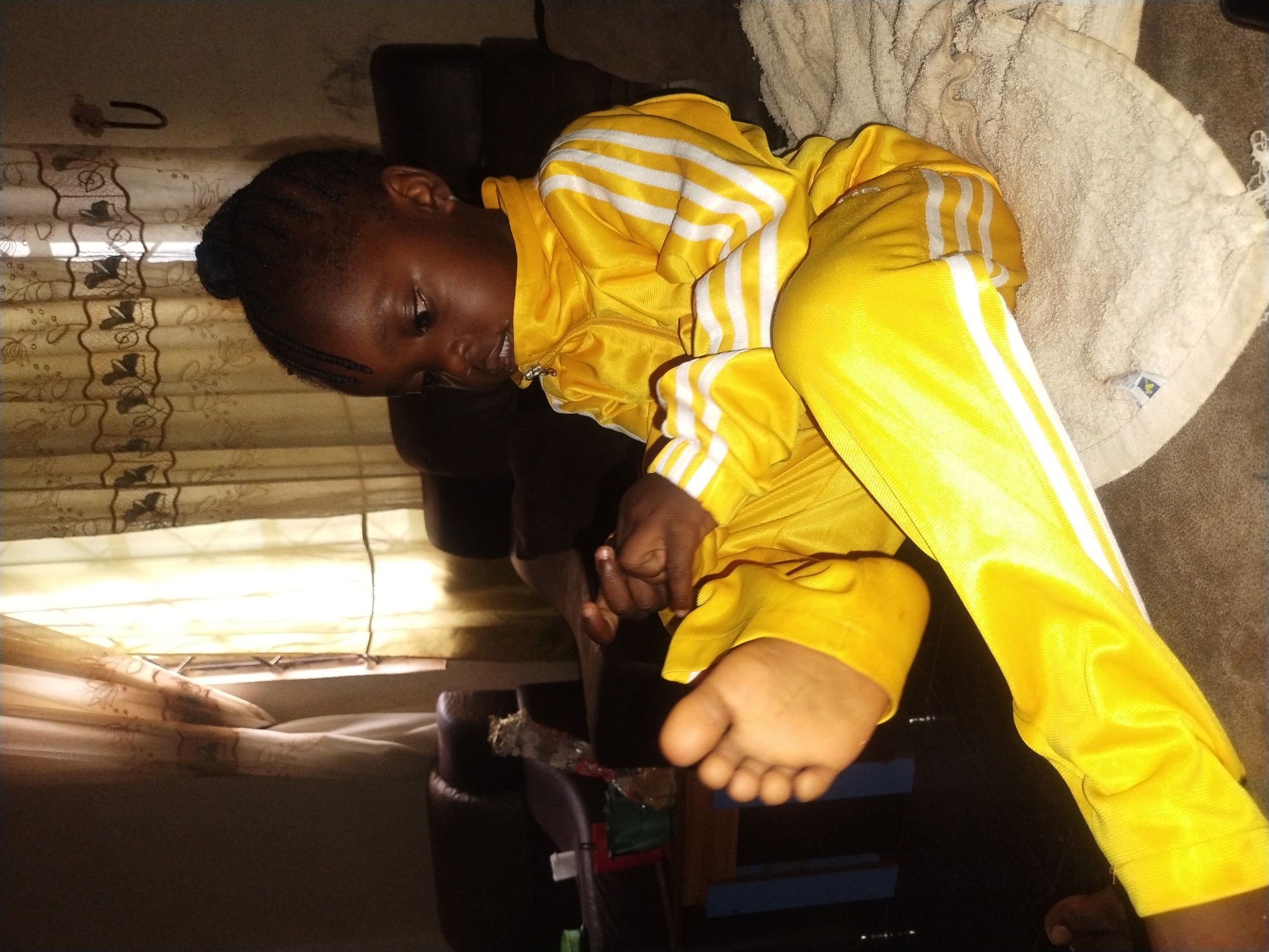 Child resting, damaged phones documented in Jos Nigeria morning