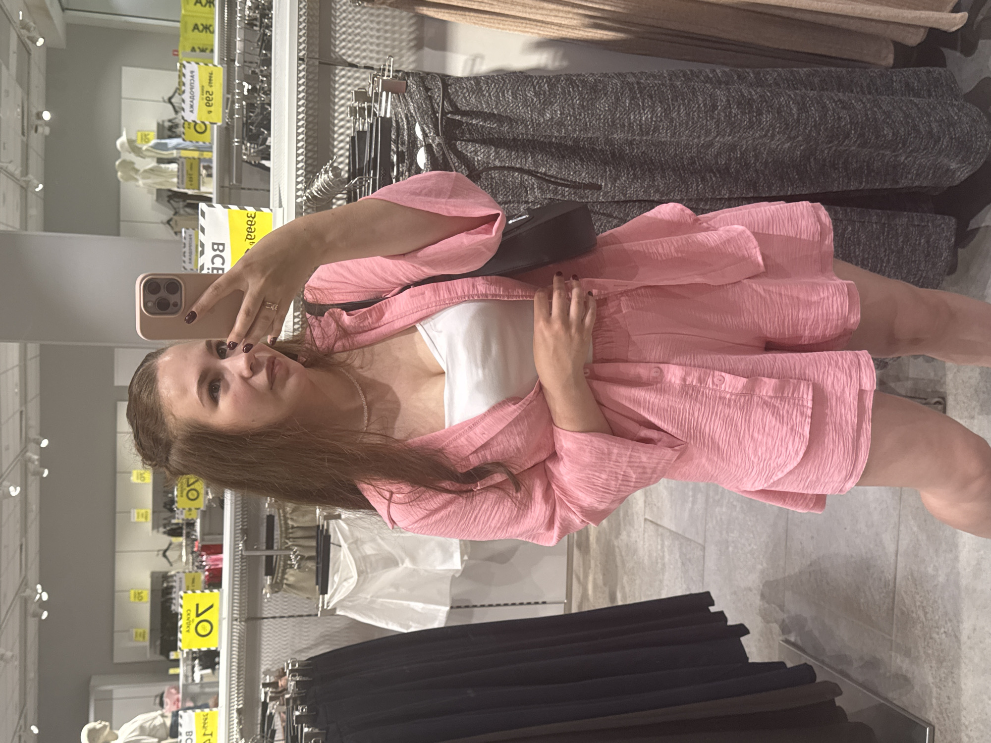 Trying on a pink two-piece set in an Izhevsk clothing store