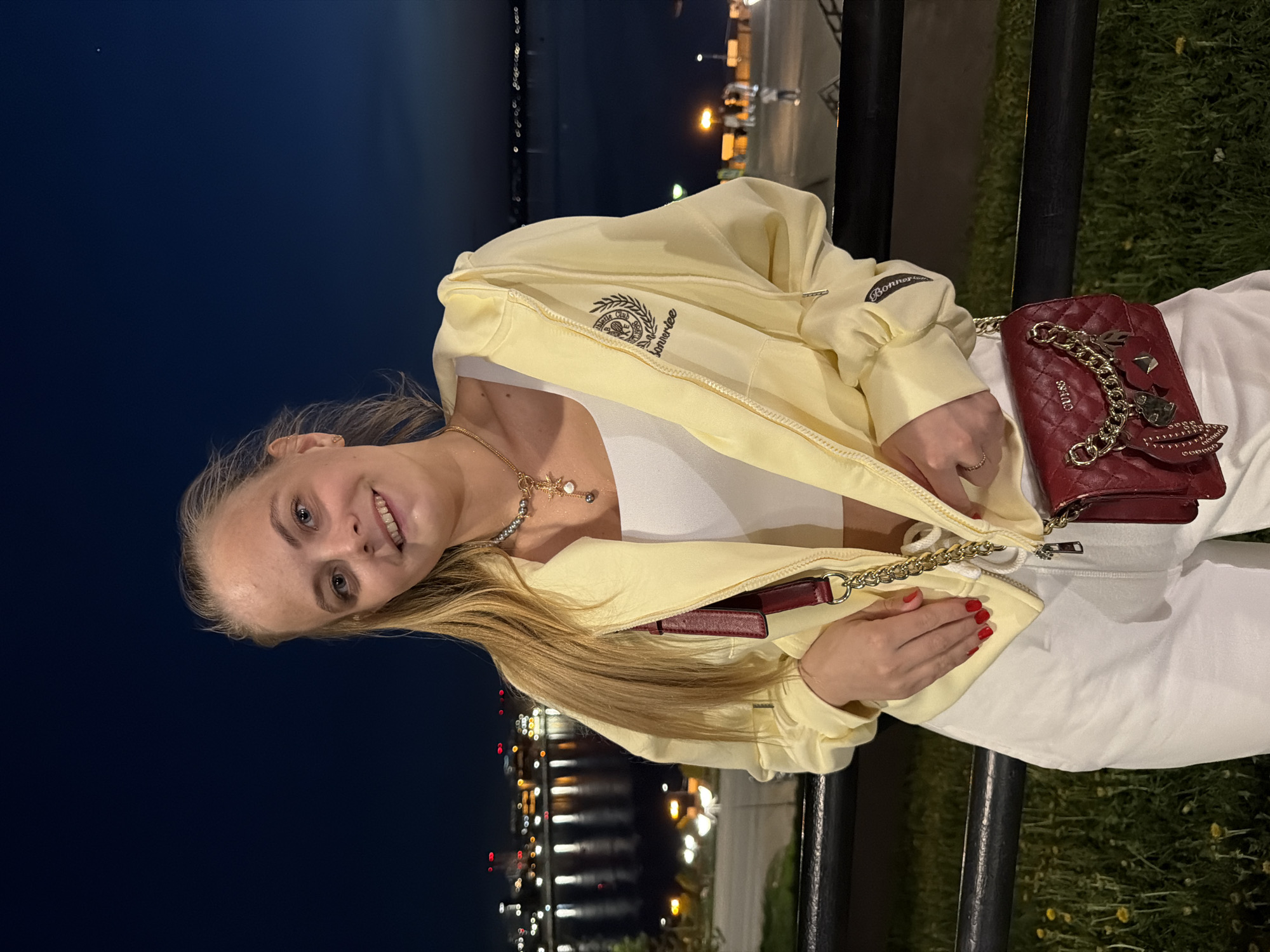 Woman observed at nighttime waterfront railing in Izhevsk, Russia