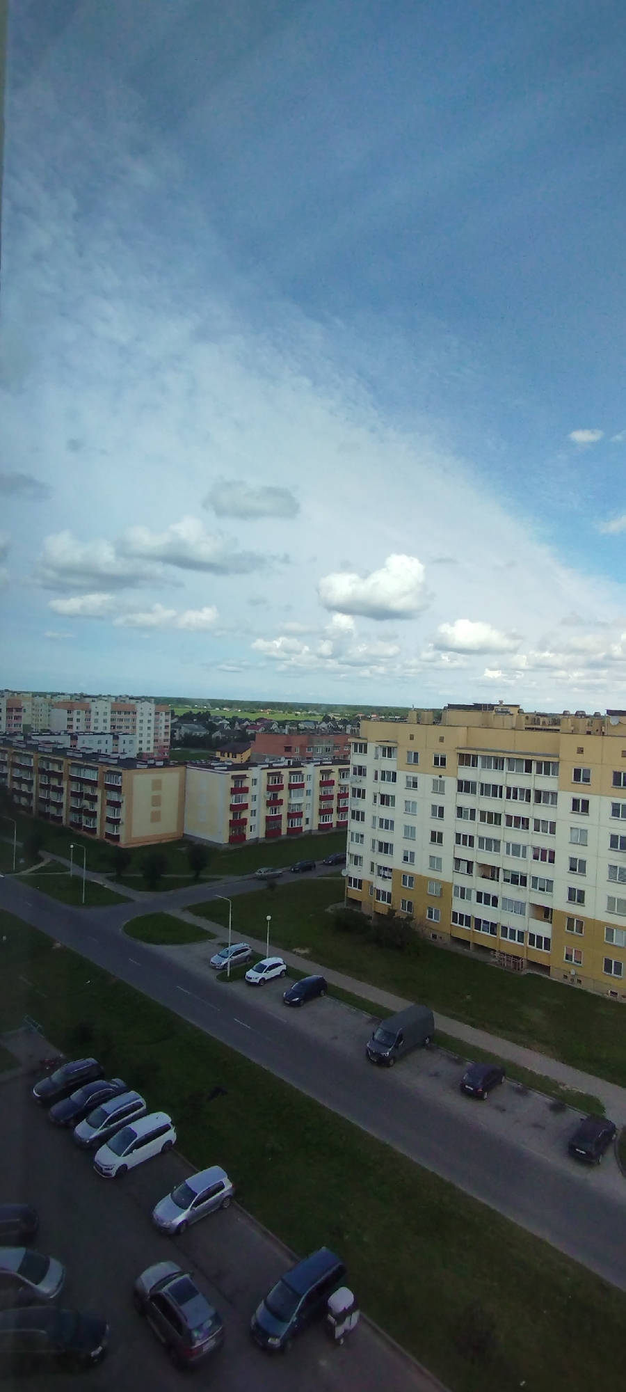 Aerial and sky-facing views over a cloudy suburban landscape