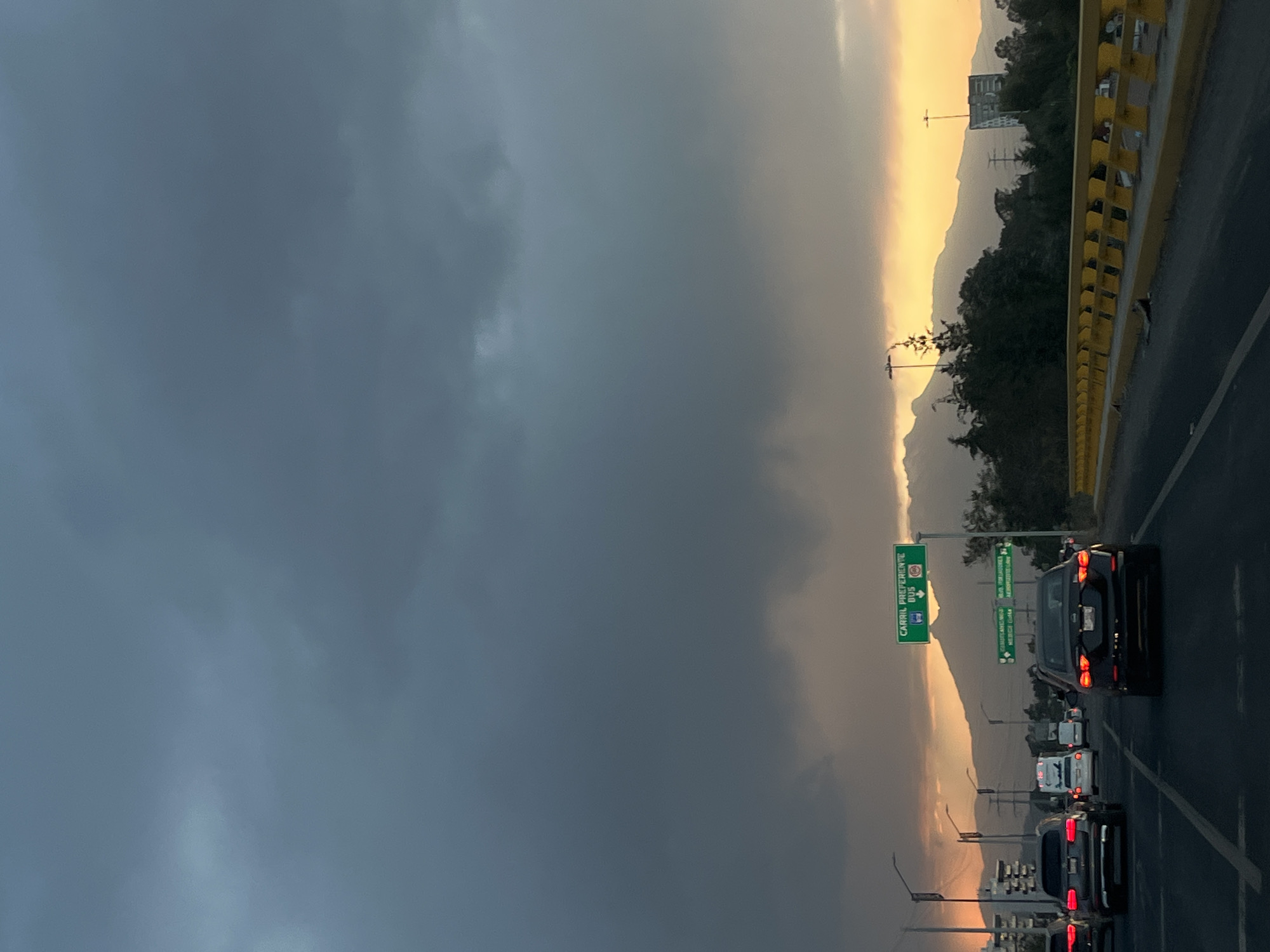 Heavy clouds blanket Cholula highway during twilight hours