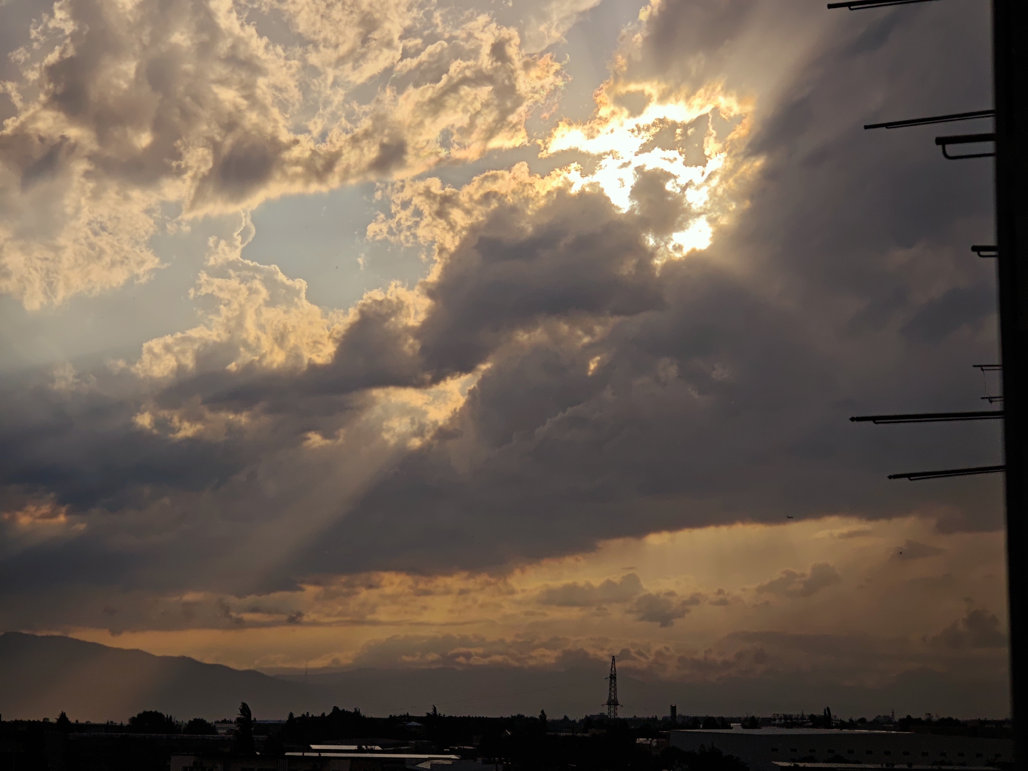 Storm system rolls over Tbilisi with rain shafts and dramatic skies