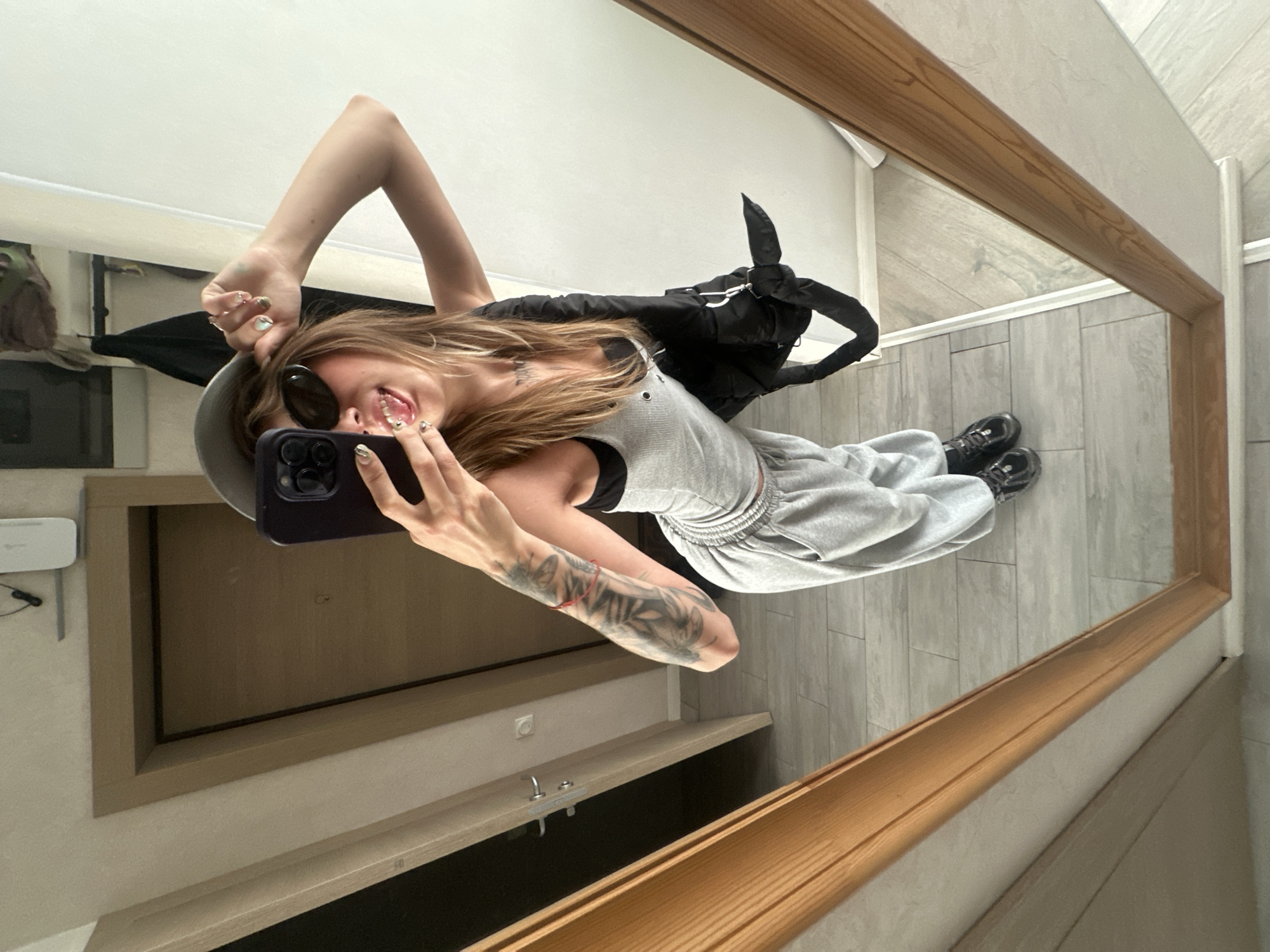 Mirror selfies in grey outfit at Moscow apartment