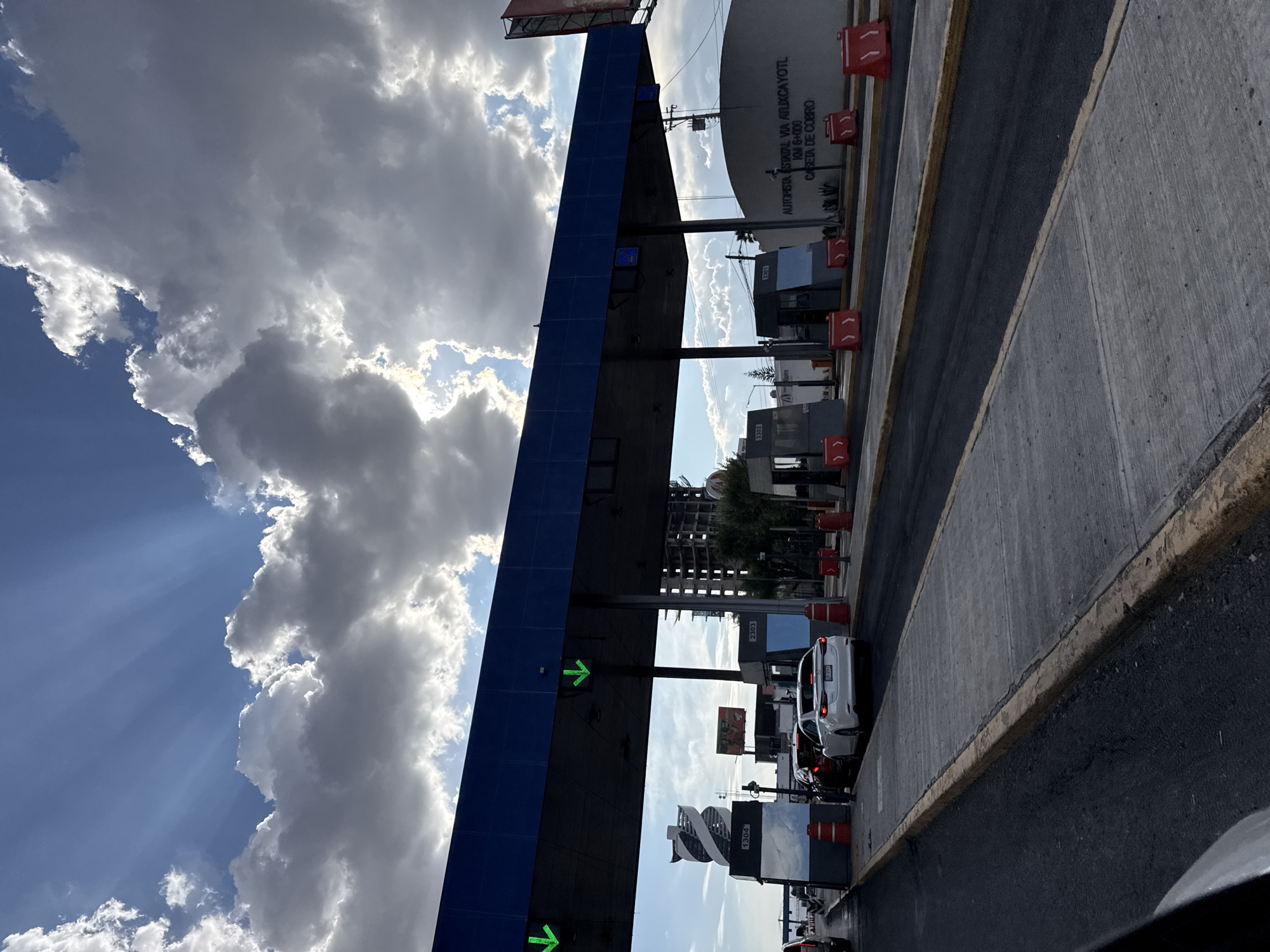 Toll booth documented on Mexican highway under partly cloudy skies