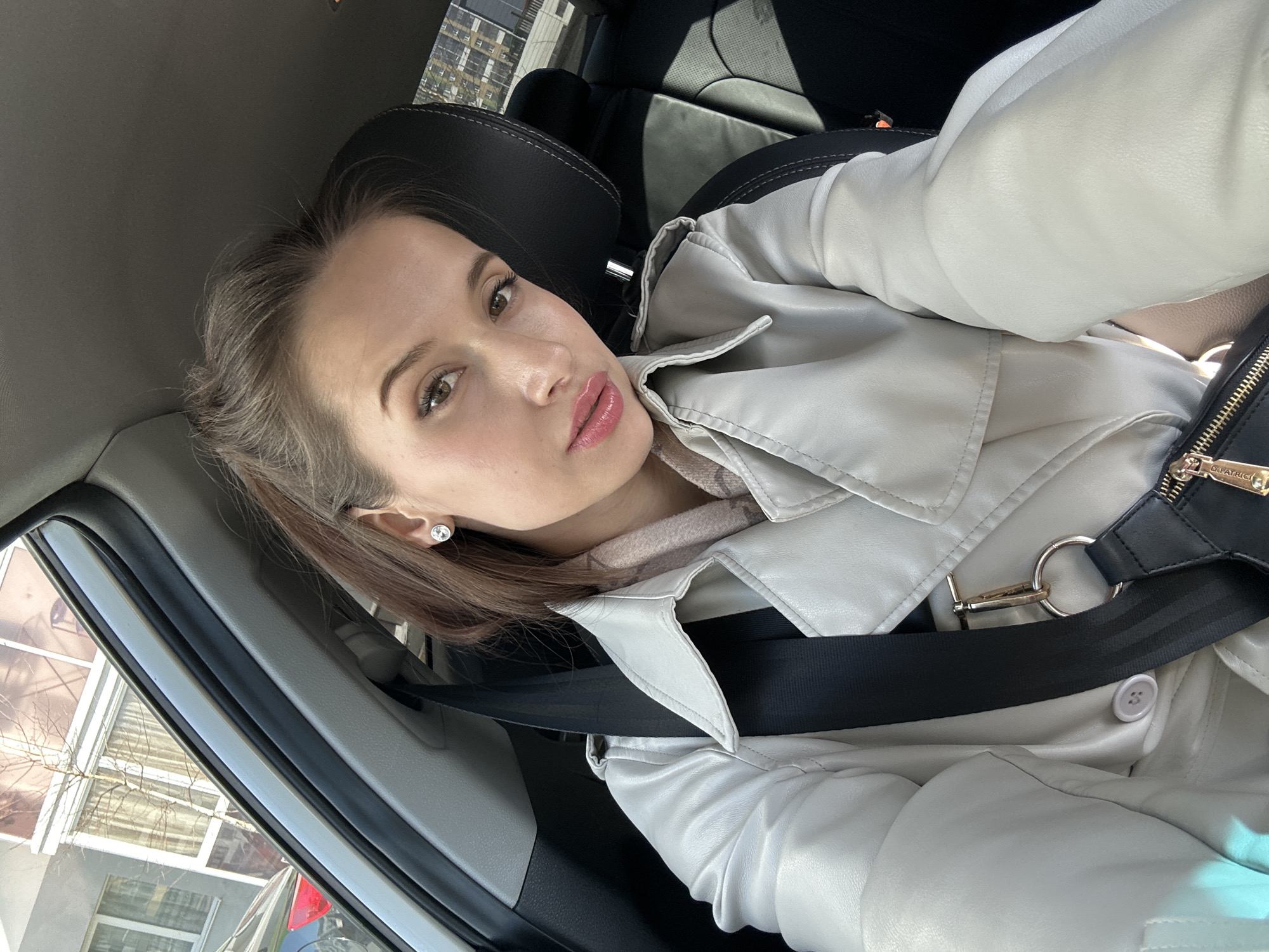 Woman takes car selfies in Yekaterinburg apartment district