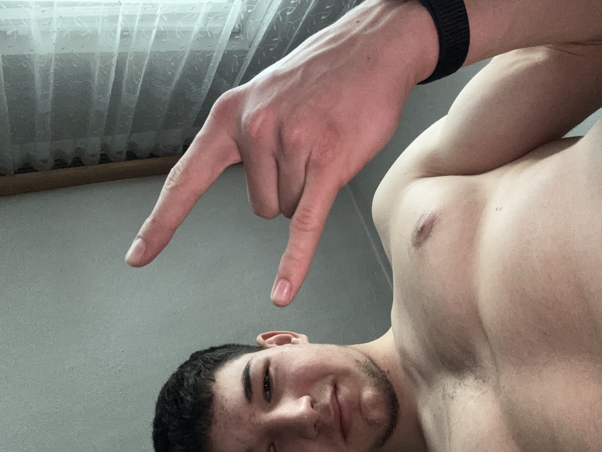 Young man takes flexing selfies indoors in Zlatograd