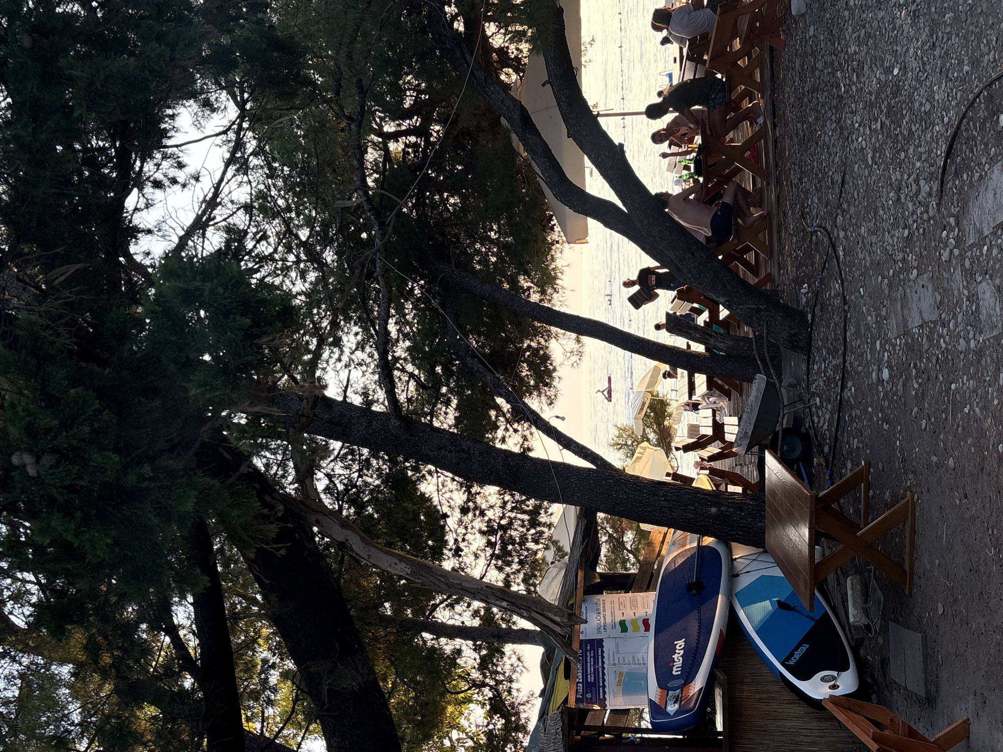Sunset beach afternoon in Bar, Montenegro — paddleboards, volleyball, Adriatic calm