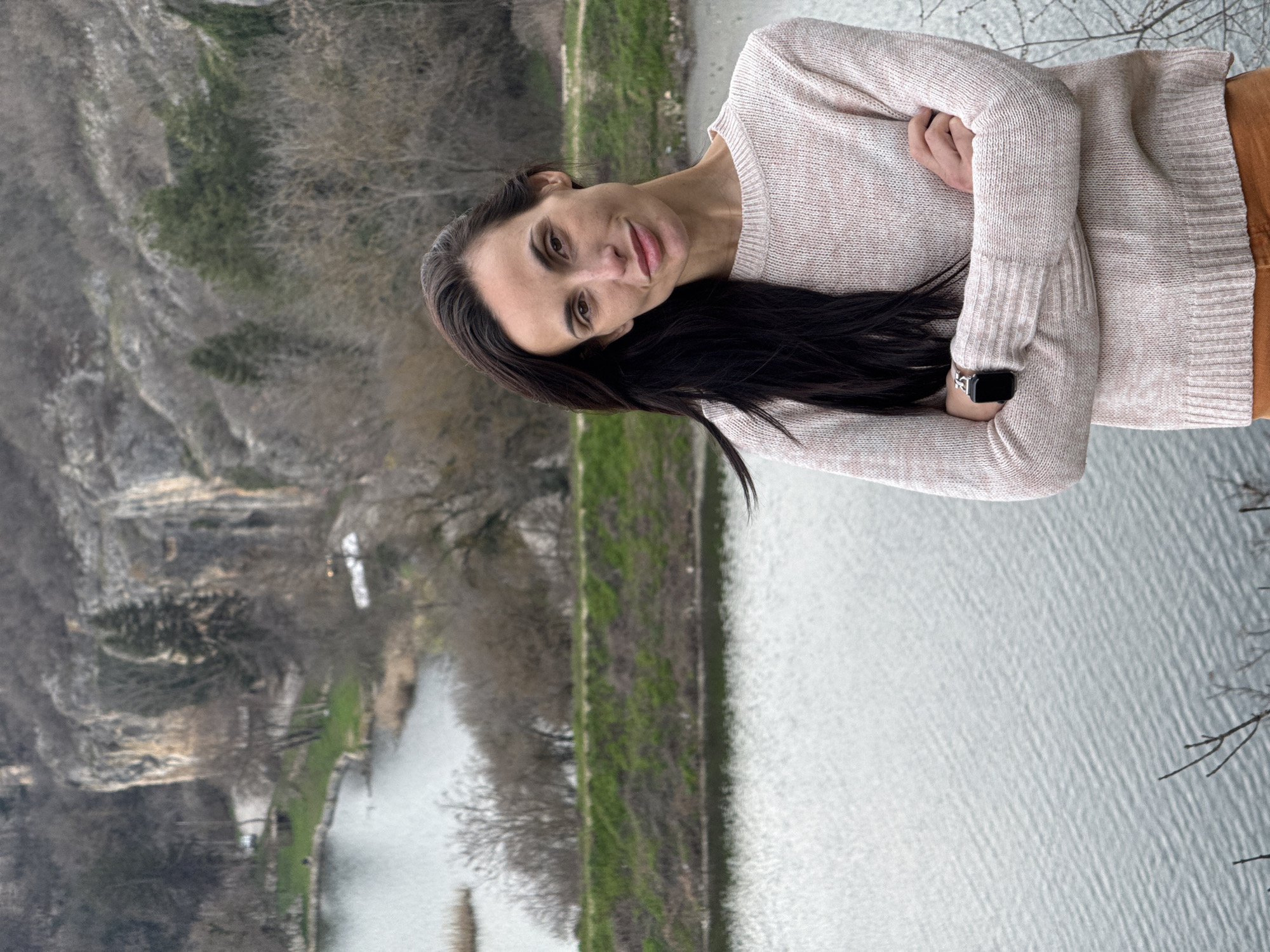 Woman photographs spring blossoms, scenic views at Bulgarian park