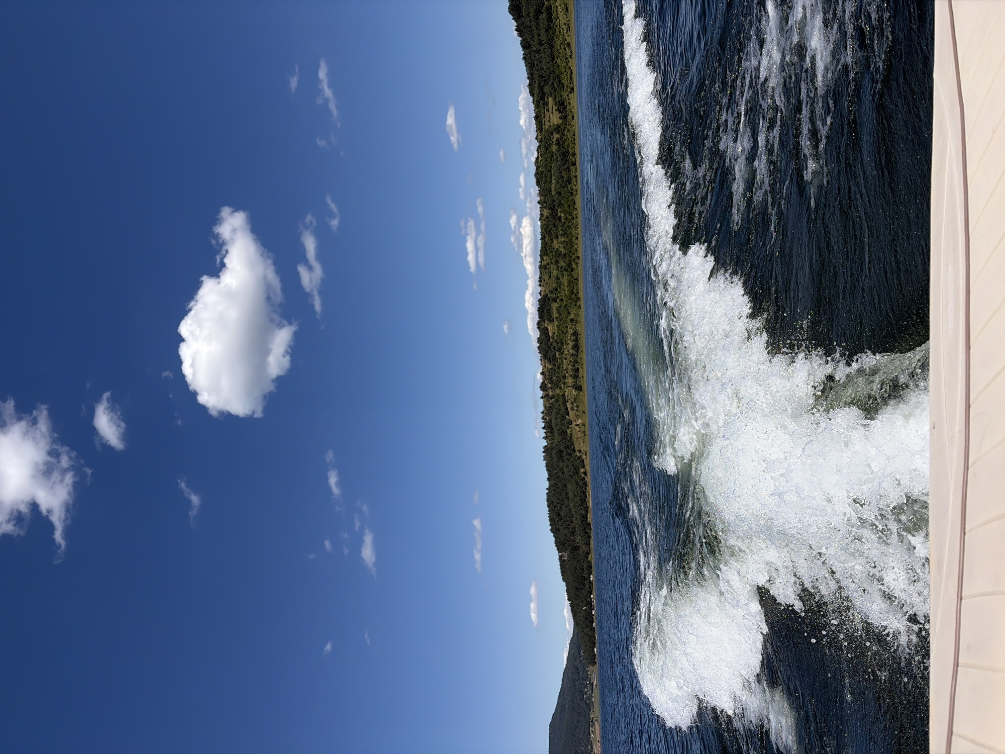 Boating across Batak's deep blue lake waters
