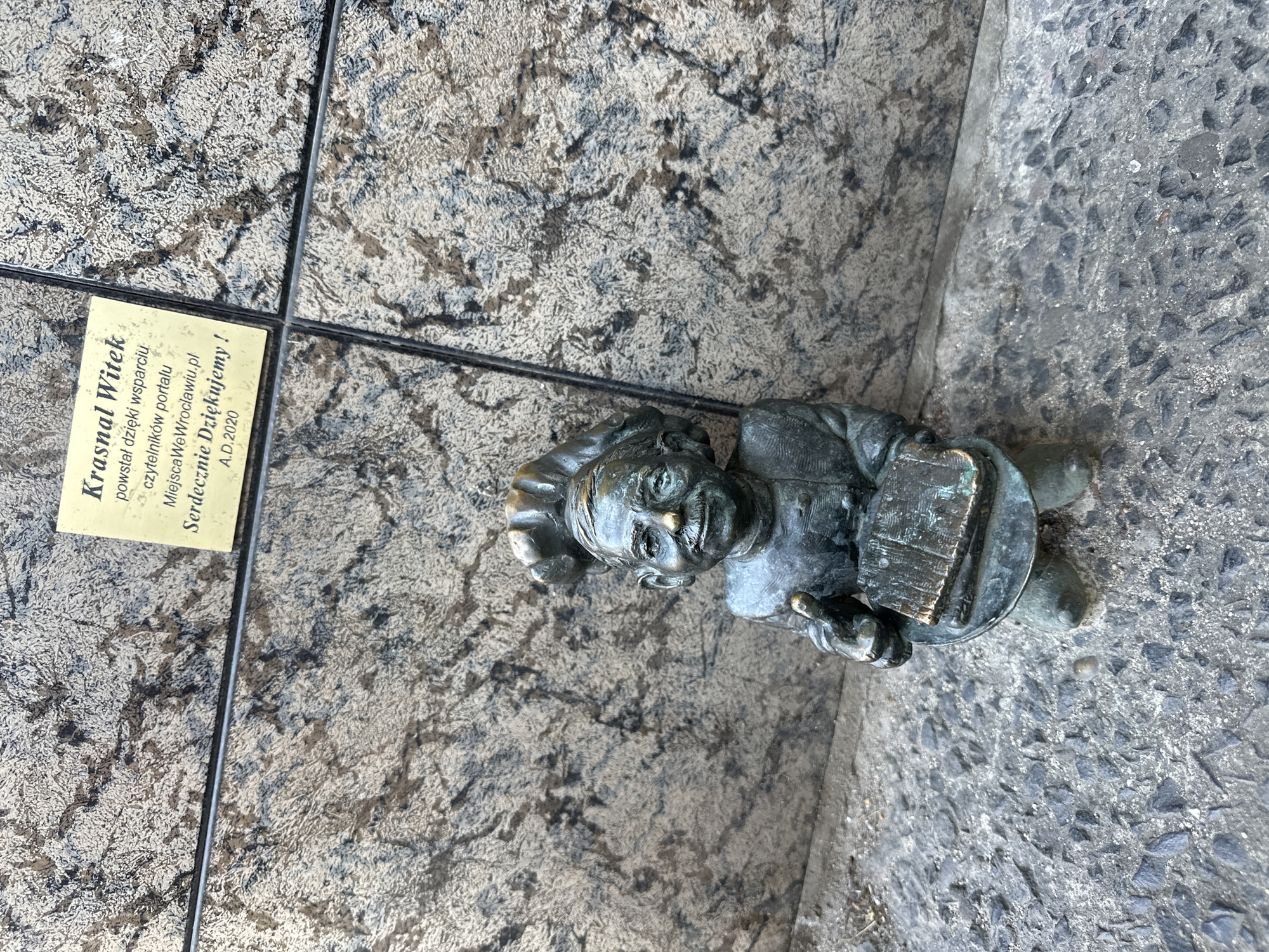 Tourists photograph iconic bronze dwarfs in Wrocław historic district