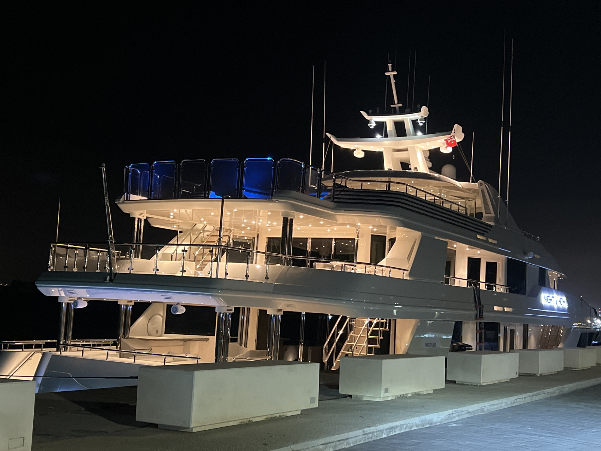 Illuminated superyacht docked at night in Gibraltar marina
