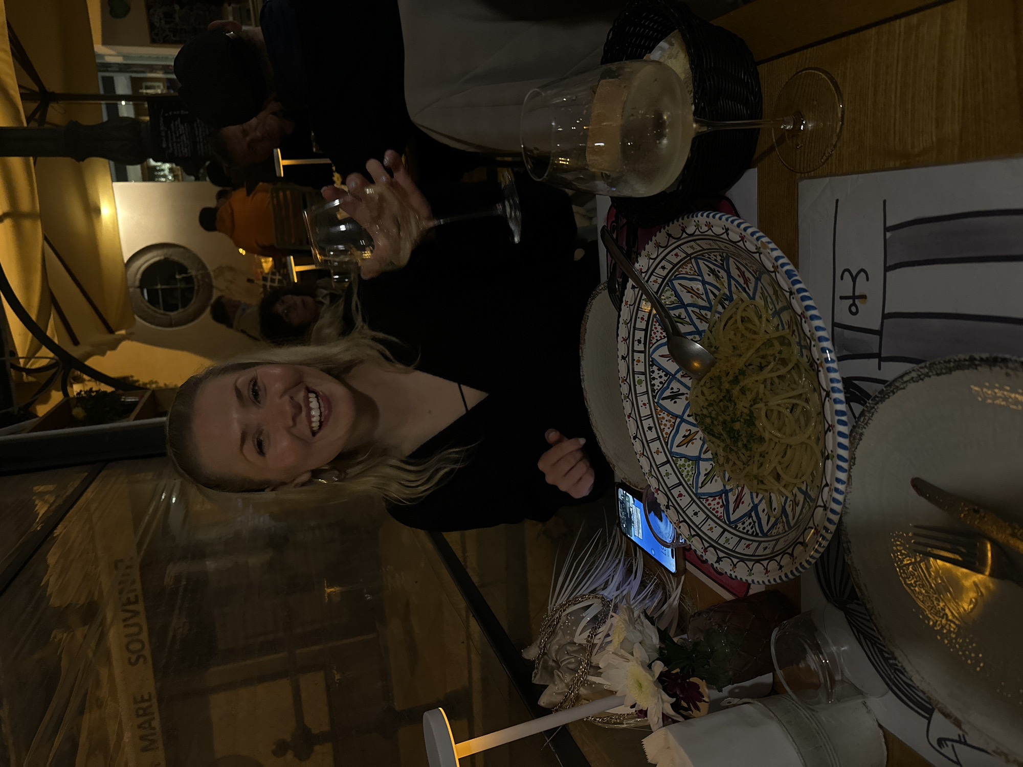 Woman enjoys evening dinner at Lipari restaurant