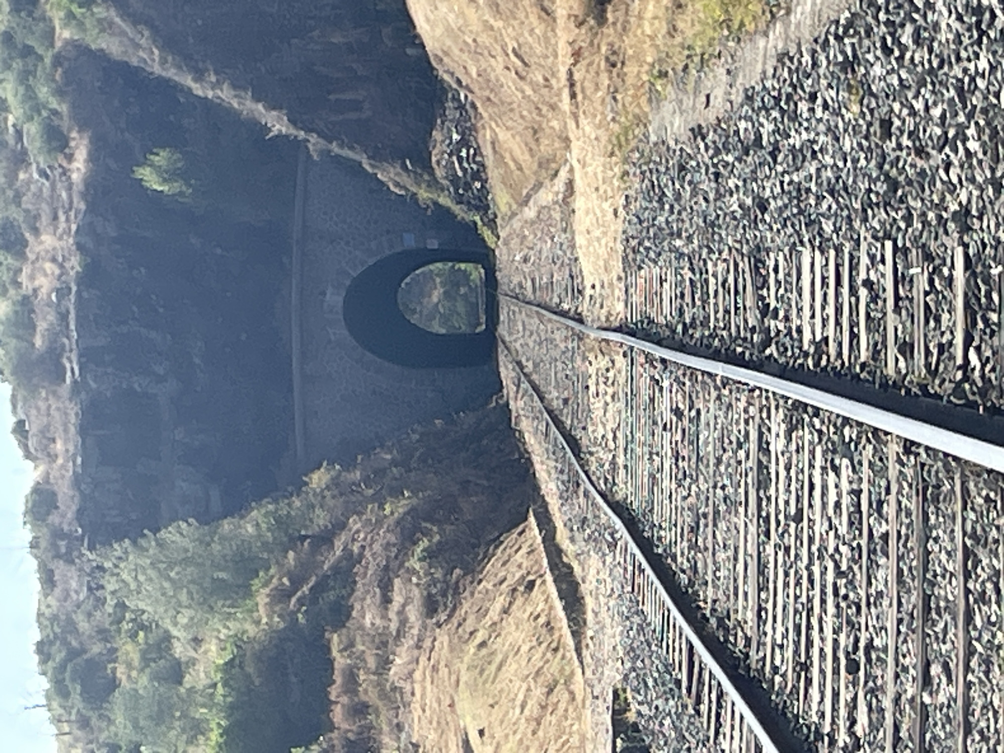 Walking an old railway tunnel trail on a clear sunny day