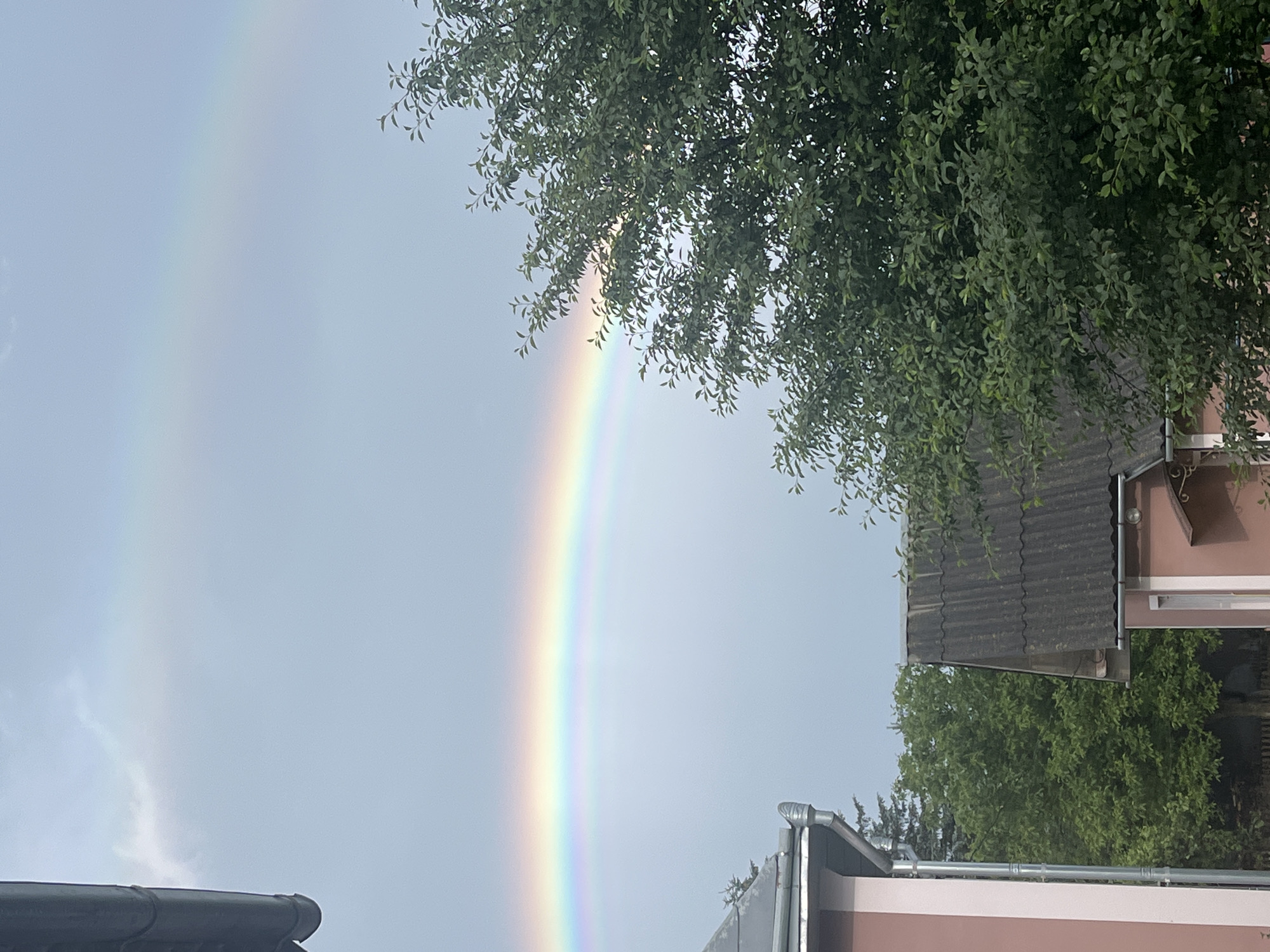 Double rainbow over gardens and orchards in Dubivtsi, Ukraine
