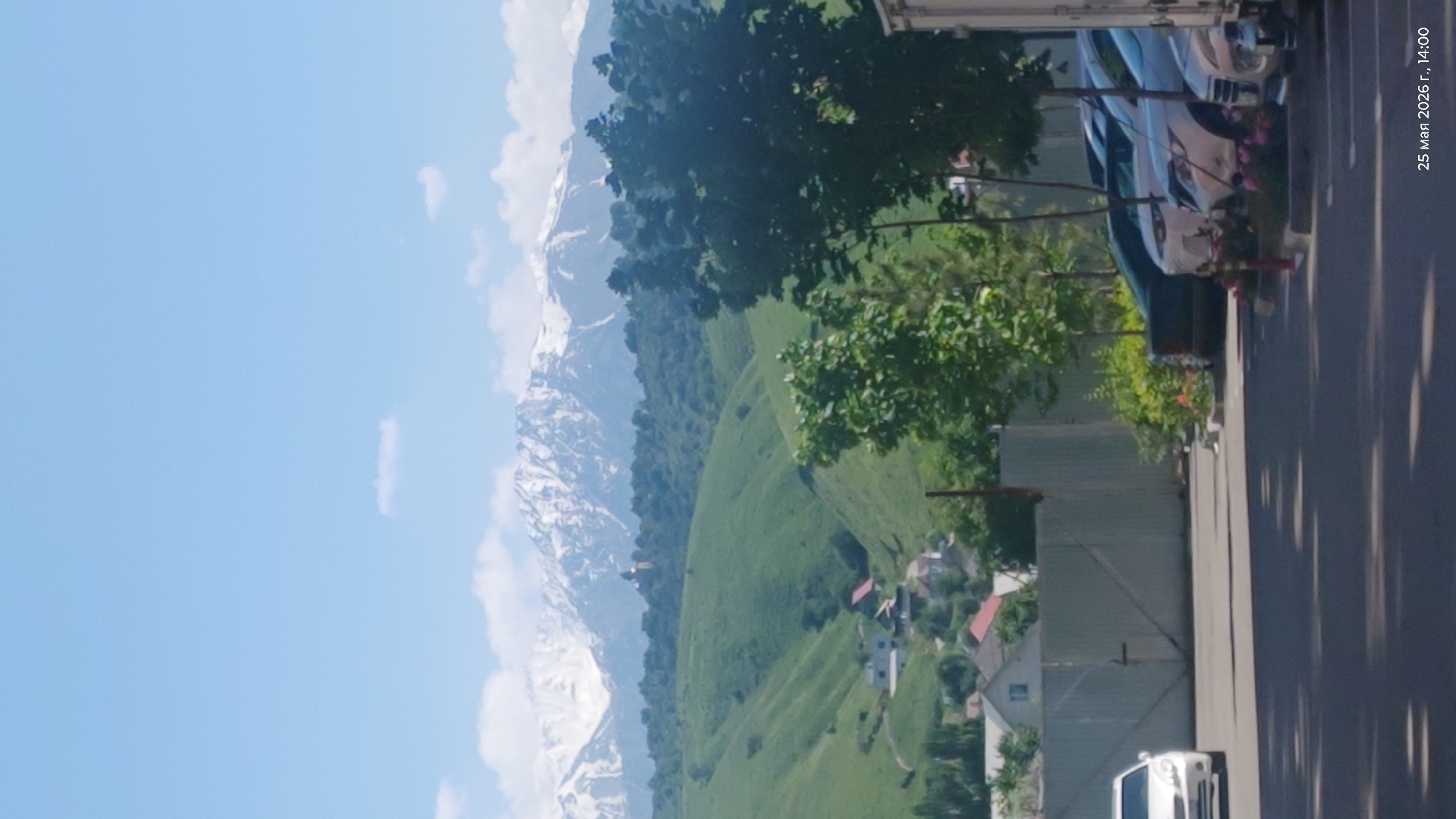 Spring landscape captured in Almaty showing mountains and scattered houses