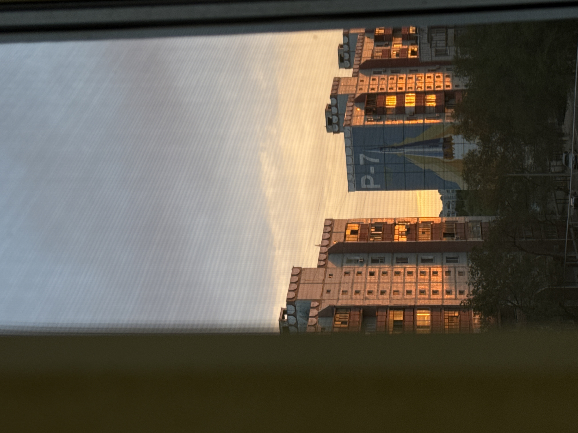 Sunset over Baikonur's Soviet apartment blocks, rockets on the walls