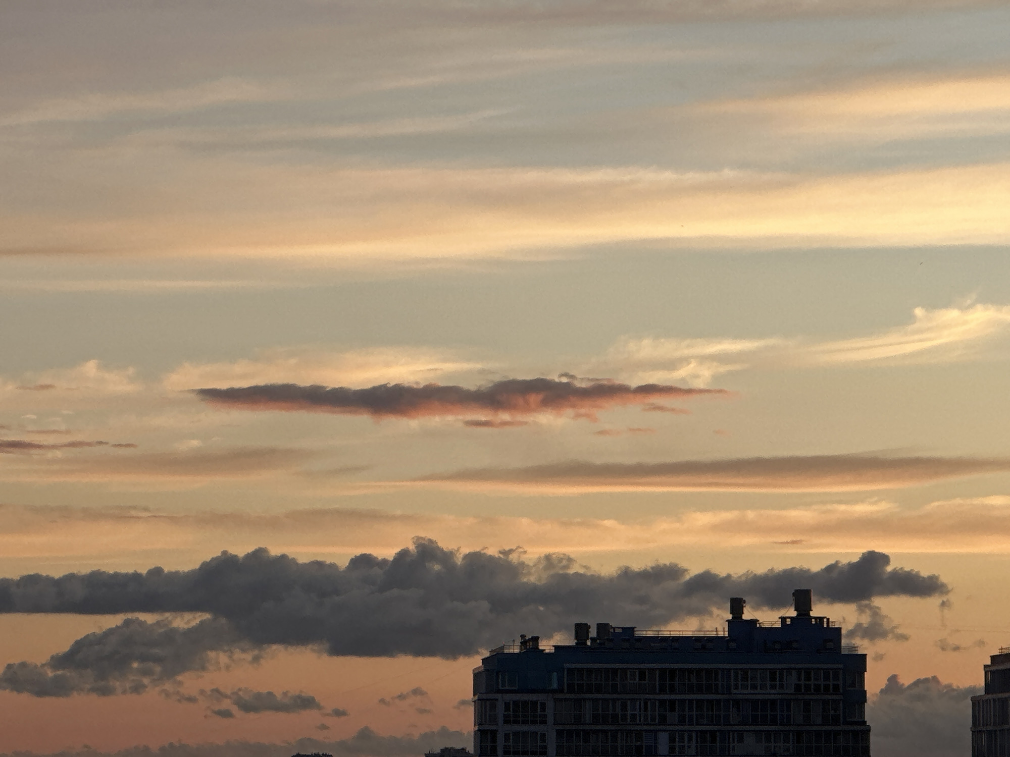 Layered sunset sky over a Russian city skyline