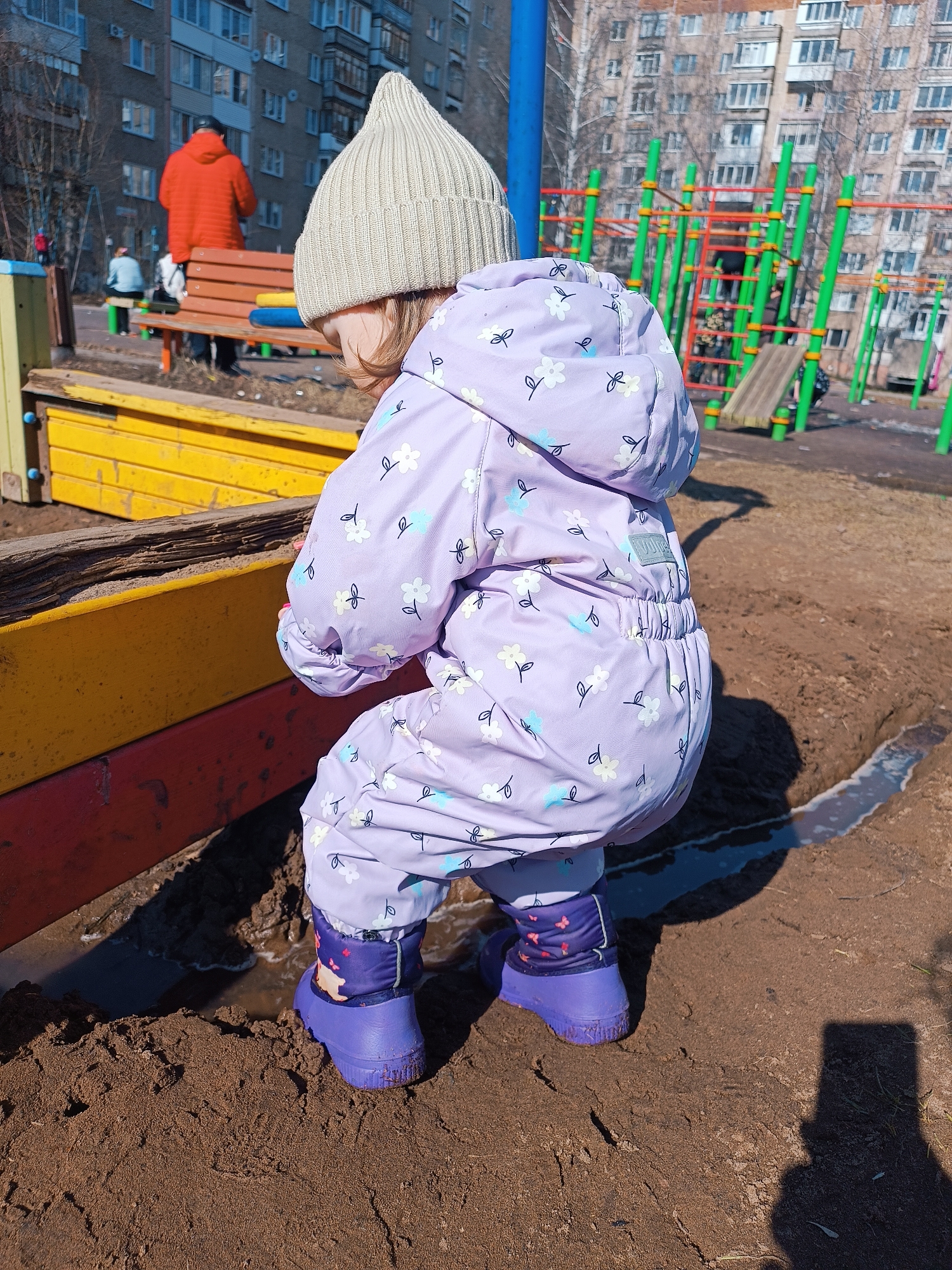 Child plays outdoors in winter clothes in Izhevsk