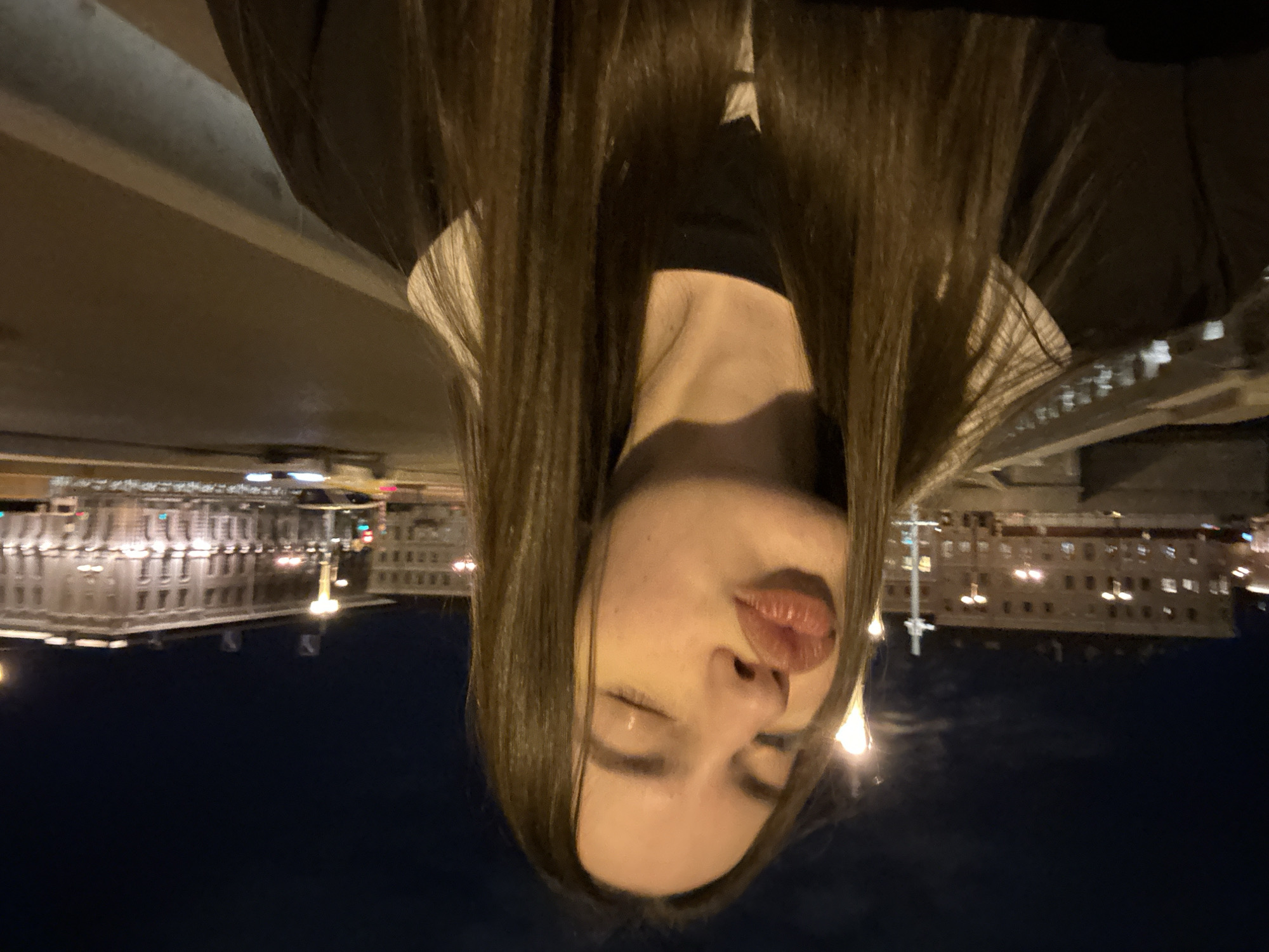 Two women walk Saint Petersburg bridge at night
